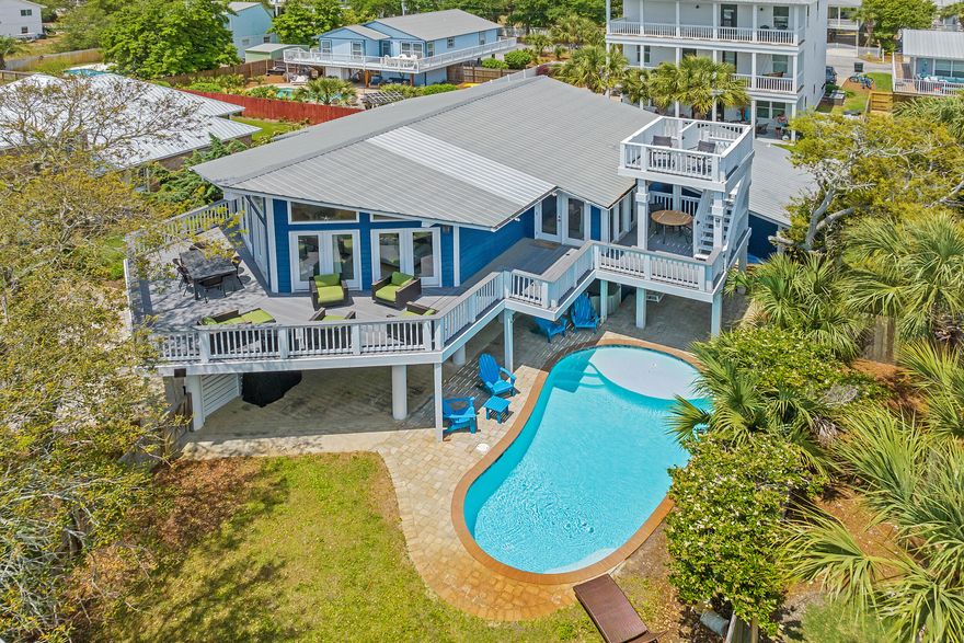With an air of mid-century style, this charming South of 30A beach retreat offers privacy on a large lot, only moments from the Gulfview Heights Regional Beach Access. This property provides plenty of space for large groups to spread across--with 5 bedrooms, 4 bathrooms, two living areas, a second-floor deck that runs along the architecture of the home and leads to a crow's nest deck with a glimpse of the Gulf, and two fenced-in yards. One area is privatized in the front, surrounding the heated pool, the other is out back, with a patio-sitting area. Beautiful live oaks offer a parklike atmosphere in front. Indoors, enjoy an open living, dining and kitchen area with a vaulted ceiling and walls of windows. Downstairs is the second master suite and recreation room with pool table and wet bar. The home has two sizeable outdoor storage lockouts for beach gear; one is a small garage. With the large bunk room, this home can accommodate groups of up to 14.

At the end of Betty Street, turn left to enjoy the Gulfview Heights Beach Access, providing parking, restrooms, showers, sheltered picnic tables, and lifeguards during peak season. 95 Betty St is approximately 350 yards to the sand.

Betty Street offers privacy away from it all, with just 28 homes on large parcels and a dead-end, there will be limited drive-through traffic.

No HOA fees or added restrictions means freedom of ownership and opportunity for creative growth and expansion.

The home is just under 3/4 a mile to the shops and restaurants at the intersection of 393 and 30A, including, Papa Surf Burger Bar, Shunk Gulley, Growler's Garage (Craft Beer), Pecan Jack's Ice Cream, The Perfect Pig and other Gulf Place amenities. 

If you are looking for a South of 30A beach home with character and an incredible, private location, 95 Betty Street belongs on your list of must-see properties.

