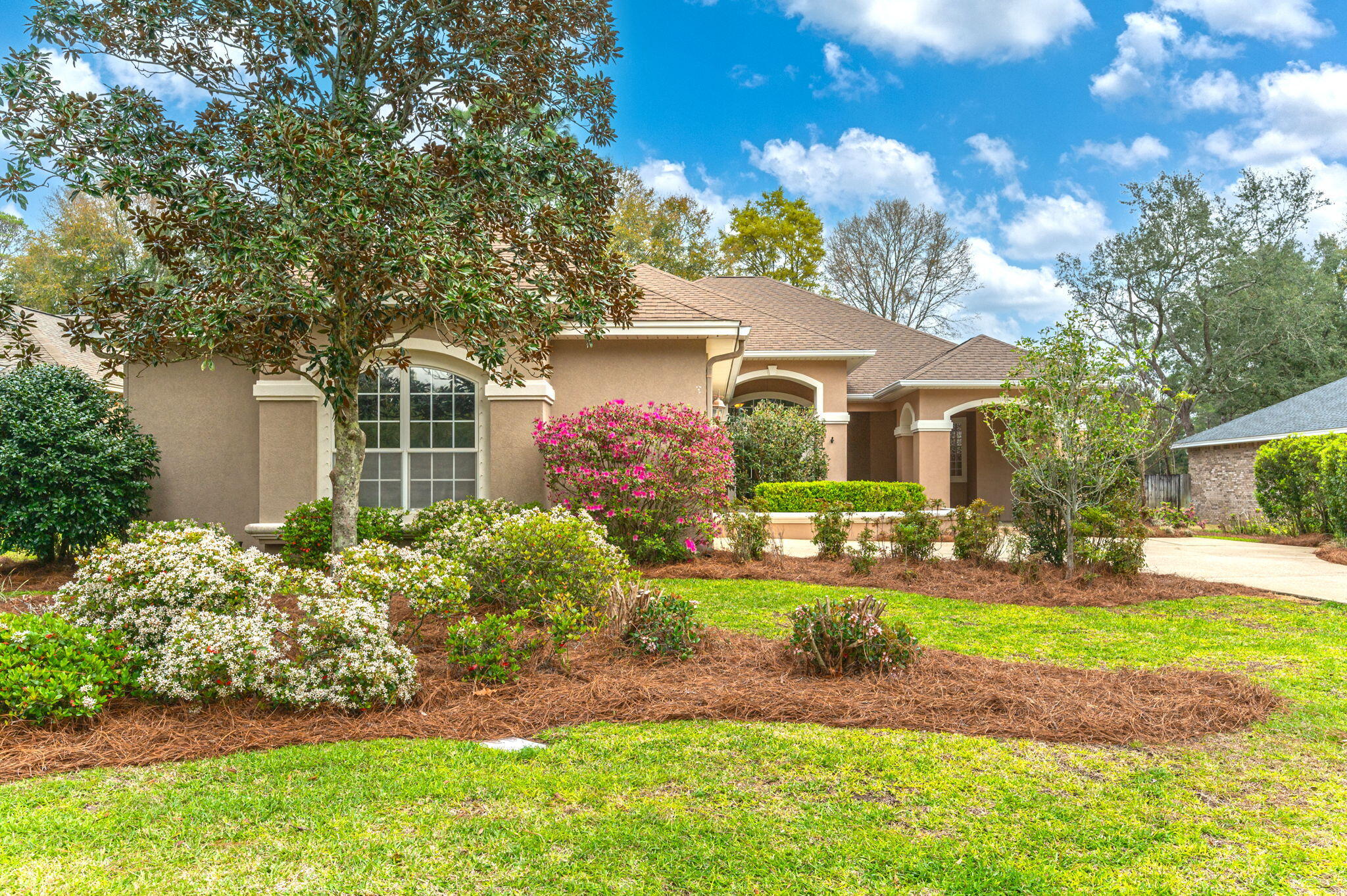 Spectacular POOL home in Swift Creek! This stunning, single story, stucco home, located on a large corner lot boasts beautiful curb appeal, mature landscaping, and an oversized side entry garage with lots of room to play and park! As you approach the home you'll enter through a large covered front porch that allows for privacy and security at the front door. Inside the foyer you'll find an open concept floor plan with NO carpet. The dedicated office is just off the entryway and features a soaring wall of built-in cabinetry and even a door towards the front patio garden. The main living area is large enough for a massive sectional and you'll enjoy the views to both the gas fireplace and the screened lanai, which can be accessed through the brand new (2024) glass sliding door! The massive