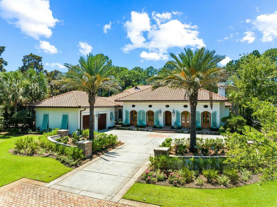 Located in the prestigious non-rental community of Burnt Pine, this completely remodeled home enjoys exceptional privacy. Meticulously maintained and lightly used as a second home, this Mediterranean-style residence is surrounded by mature trees and backs up to the 11th fairway of the golf course. A two-car garage and a row of shuttered windows announce the covered entrance. Step inside and enter a seamless, sophisticated world where custom cabinetry and modern technology enhance the stunning floor plan. Designed for functionality and entertaining, the gracious formal dining room and living room boast custom chandeliers, a fireplace, crown molding and many extras. The custom-built bar has an integrated Sub-Zero wine cooler and is perfect for amateur mixologists to create and serve signature cocktails. Professional decor in muted tones complements the marble and hardwood flooring. The home showcases the Ferrari of kitchens with custom cabinets, high-end Wolf and Sub-Zero appliances and a walk-in butler's pantry, all designed to make entertaining easy. Two dishwashers, an under-counter beverage refrigerator, a six-burner gas stove, a double range, an ice maker and an integrated coffee station are just some of the refinements surrounding the marble-topped island. Retire to the exquisite master bedroom, which has custom cabinetry incorporating a Brown safe. The adjoining luxurious bathroom has a deep garden tub, dual vanities and an enhanced steam shower. In addition to the master bedroom being on the first level, there is a luxury guest suite wing as well that has its own built-in refreshment center. The other two bedrooms are located on the second level; each with their own ensuite baths and private balconies. The rear courtyard wraps around a large pool and water features, overlooked by three screened porches on two levels. There's ample space for alfresco dining and relaxing in the peaceful park-like setting. A covered porch houses the outdoor kitchen, complete with a Wolf gas grill at one end and a cozy fireplace at the other. An outdoor TV and audio system make this a year-round place to enjoy. The whole house has an ultra-smart home configuration with true remote operation, allowing owners to monitor audio, video, lighting and shade control onsite or from afar. Additional upgrades include LED Lutron lighting, HighSEER air-conditioning systems, dehumidifiers, tankless hot water, an electronic door-locking system, cameras, water filtration and a water pressure booster. The upgraded landscaping includes perimeter fencing, irrigation and lighting. Surrounded by a new travertine deck, the pool has new pumps, filters and a heater. With endless golf, watersports, a marina, boutique shopping and high-end dining nearby, this Sandestin home has it all.