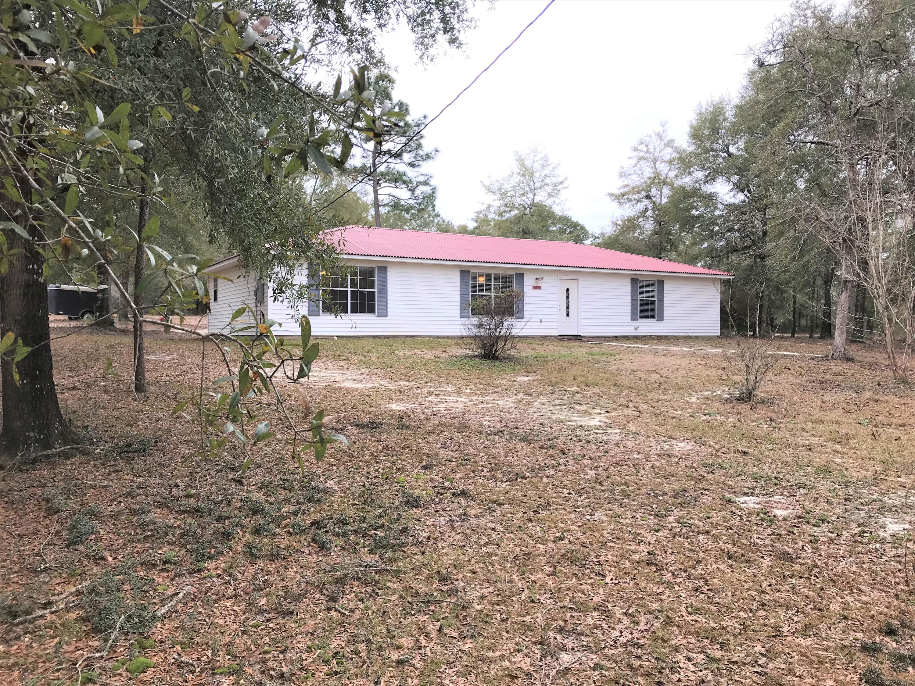 Simply beautiful is how I would describe this property. This up to date home sits on approx. 4 acres down a quite road in East Crestview. The land is flat and partially cleared. No restrictions means bring the horses or other animals. There is plenty of room to add out buildings or barns. This home features a split floor plan open design. The red metal roof was put on in 2018. AC inside and out replaced in 2017. Appliances are new. The washer and dryer are newer and stay as well. Upgraded insulation in attic area. New flooring in main living areas. New paint throughout. This us a wonderful home design with no wasted space. Each room has huge walk in closets. The kitchen is a dream with plenty of cabinets and counterspace. The acreage is a portion of the total lot. approximately 4 acres.