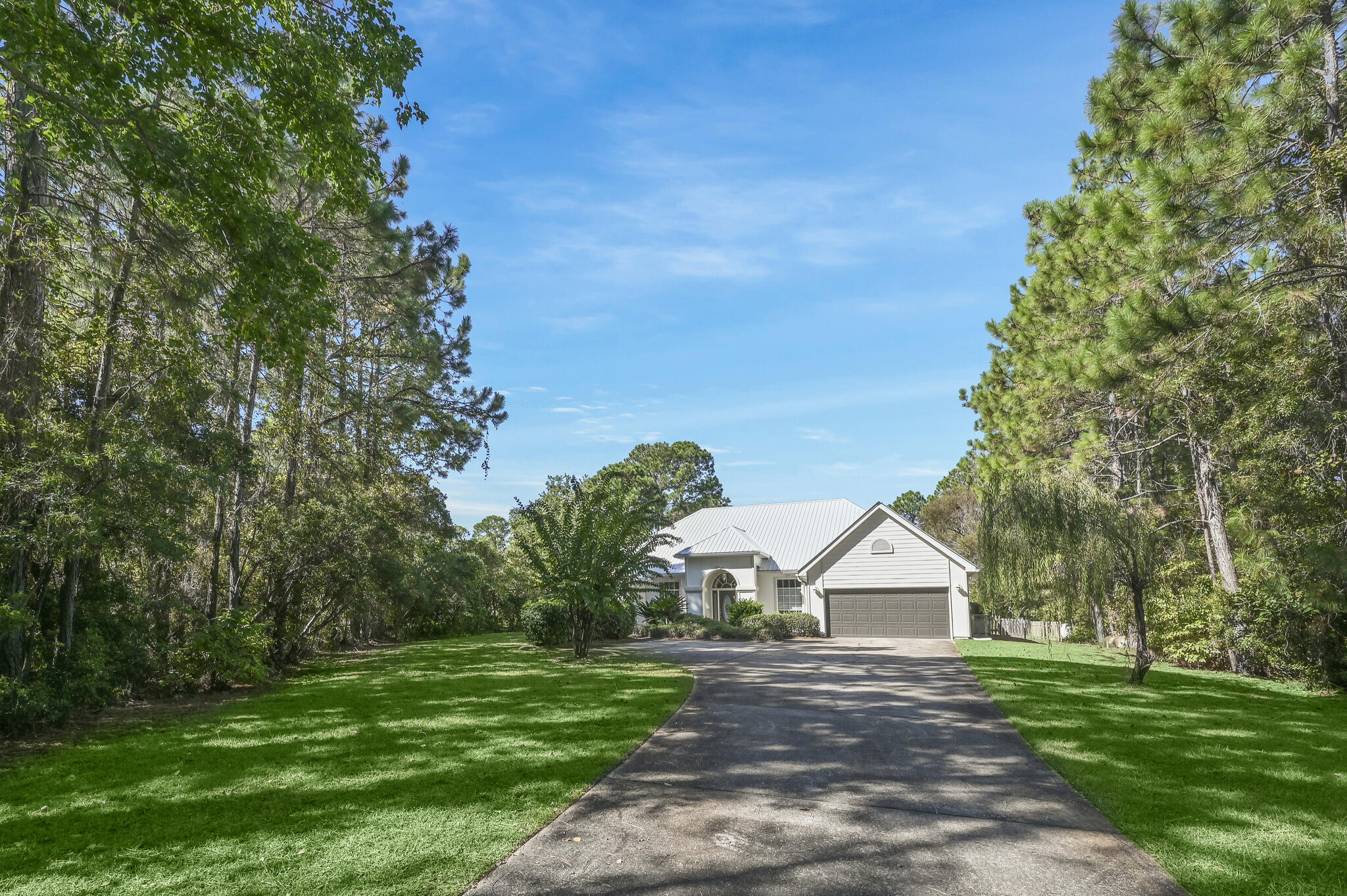 PRICE REDUCED! Spacious Ranch uniquely situated in private estate setting on beautiful 1.11 acre site with driveway access from Woodland Bayou Drive  and Don Bishop Road in the rear. Woodland Bayou Dr. is a low traffic, 'No Thru' street. Open floor plan features high ceilings, LVP flooring, custom eclectic finishes throughout. Beautifully landscaped rear yard boasts huge covered gazebo, 1,000 'sq workshop/artist studio with unlimited possibilities including finishing out as guest quarters. There is additional covered and driveway parking at rear entrance off Don Bishop Road, as well as a metal RV shed. New galvalume metal roof and hot water heater installed main house 2022. All new paint inside and out.  Furnishings negotiable. If 'unique is what you seek' this property has much potential!