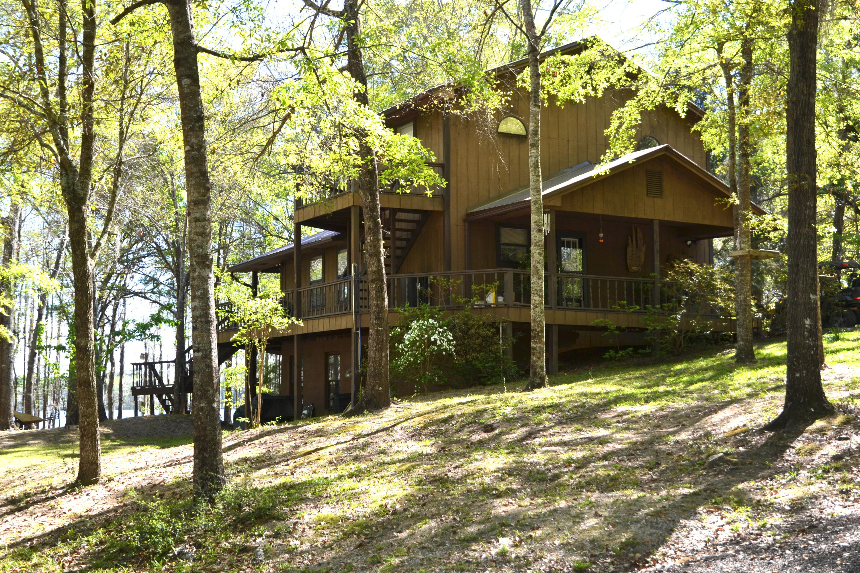 Lakefront RETREAT w/3.5 Acres near Defuniak Springs! Located on an 85+ Acre, spring-fed lake called ''Blue Pond.'' Make this home your primary residence or vacation home! 20 x 20 workshop, covered parking w/electrical hookup for your RV, along with additional RV hookups on the property, 2 Boardwalks to enjoy surrounding nature, walk around deck on the home, and an unfinished basement w/poured slab. Live on the first floor w/a fully equipped kitchen; dining area; living room and bedroom w/lake view; and full bathroom. Huge Covered and Open Deck is a great outdoor space! Located on the 2nd floor is considered the master suite w/bathroom having a double vanity and bedroom access to the outside. Laundry room and 3rd full bathroom is located in the walk-out basement. Schedule your VIEWING!.....