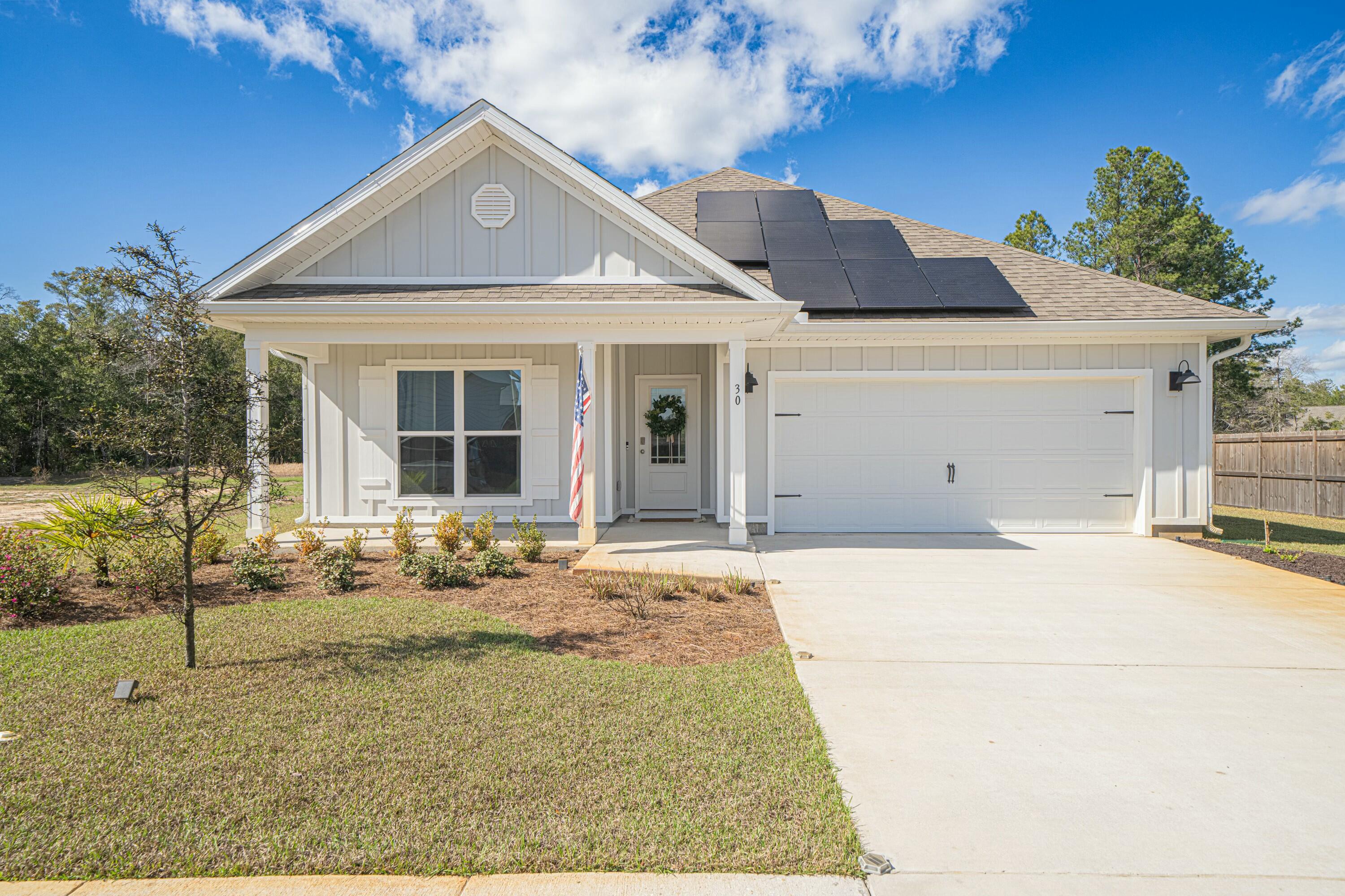 SOLAR TO BE PAID OFF BEFORE CLOSING! ASSUMABLE VA LOAN! Welcome to 30 Oak Trees Lane W, a charming single-family home nestled in the serene and secluded community of Hammock Oak Estates. This modern residence offers comfortable and open living space with 4 bedrooms and 2 bathrooms, beautiful outdoor area, and the benefits of solar living! As you step inside, you'll be greeted by the first 2 bedrooms and 1 bathroom that seamlessly connect to the living, dining, and kitchen areas, creating an inviting atmosphere perfect for both relaxation and entertaining. The kitchen is equipped with stainless steel appliances, ample cabinetry, and a convenient center island, making meal preparation a delight. The primary suite features a spacious bedroom and beautiful bathroom with a walk in closet. Going out the back door to enjoy your lovely waterfront views with nature as far as you can see will never get old.
The homes 2 car garage with maximized attic storage just boosts the functionality of the home.The beauty and functionality here is exquisite.