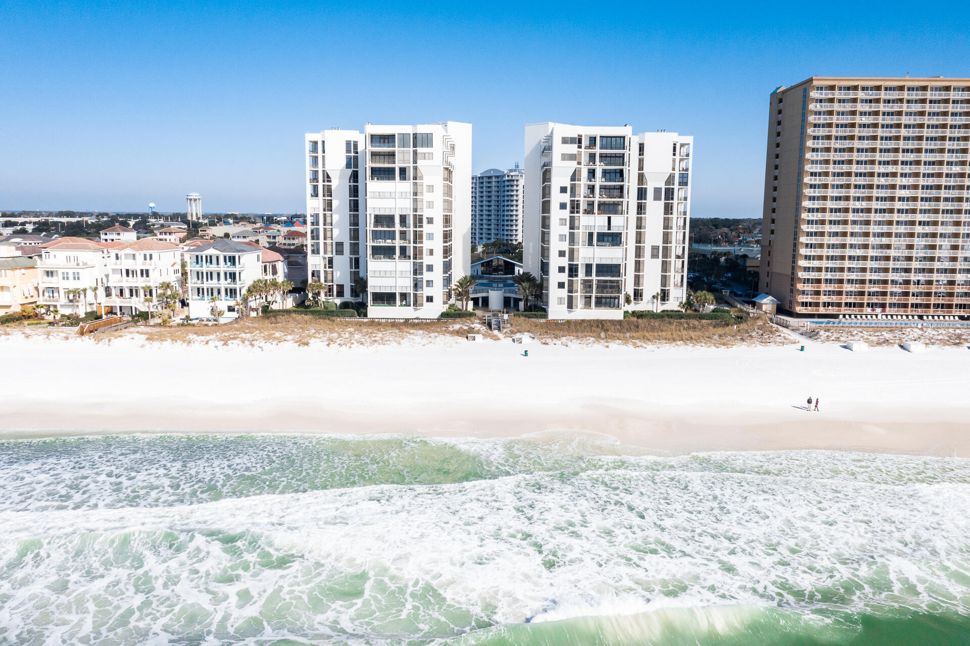 Completely renovated luxury Gulf front condominium in the ultra-private Regency Towers. Behind the gates you will find 44 Gulf front, non-rental condominiums with sweeping views, private deeded beach, Clubhouse, tennis, pool, fitness center, sauna, and onsite Security & HOA Office.  This 7th floor unit with floor to ceiling windows provide breathtaking views of the Gulf from every room! No expense was sparred with the renovation and rebuilding adding new flooring, kitchen & bath cabinetry, countertops, recessed lighting, reconfigured floorplan, wet bar with ice maker & beverage refrigerator, enlarged master closet, expanded laundry room, modern tile in all the bathrooms and outstanding light fixtures. All new appliances along with new HVAC systems. Two units per floor with a shared lobby