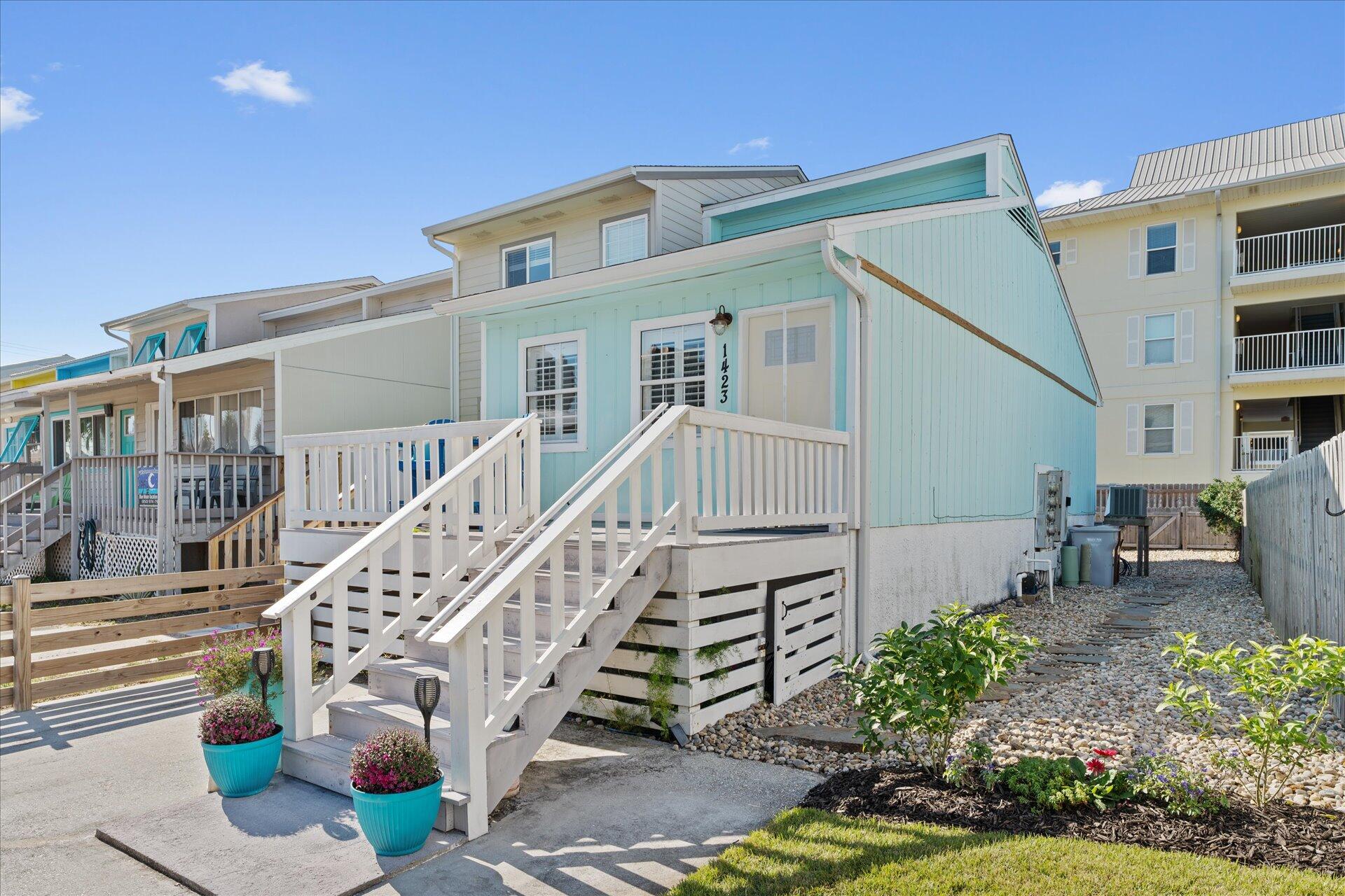 This charming 1-bedroom, 1-bath beach cottage is the perfect coastal retreat.  Completely furnished, just waiting for you to unpack and relax. Only steps from the Gulf of Mexico and the Santa Rosa Sound. No HOA Fees. This cottage features an open-concept living space with large windows that flood the interior with natural light. The cozy bedroom allows access to a large covered deck. Both the updated kitchen and bathroom boast all modern fixtures, appliances and granite,  LVP flooring throughout. This end of group townhome offers a larger and private back and side yard.  A Navarre Beach cottage combining loads of comfort and charm, making it an ideal getaway for those seeking relaxation by the sea. for themselves and their guests.