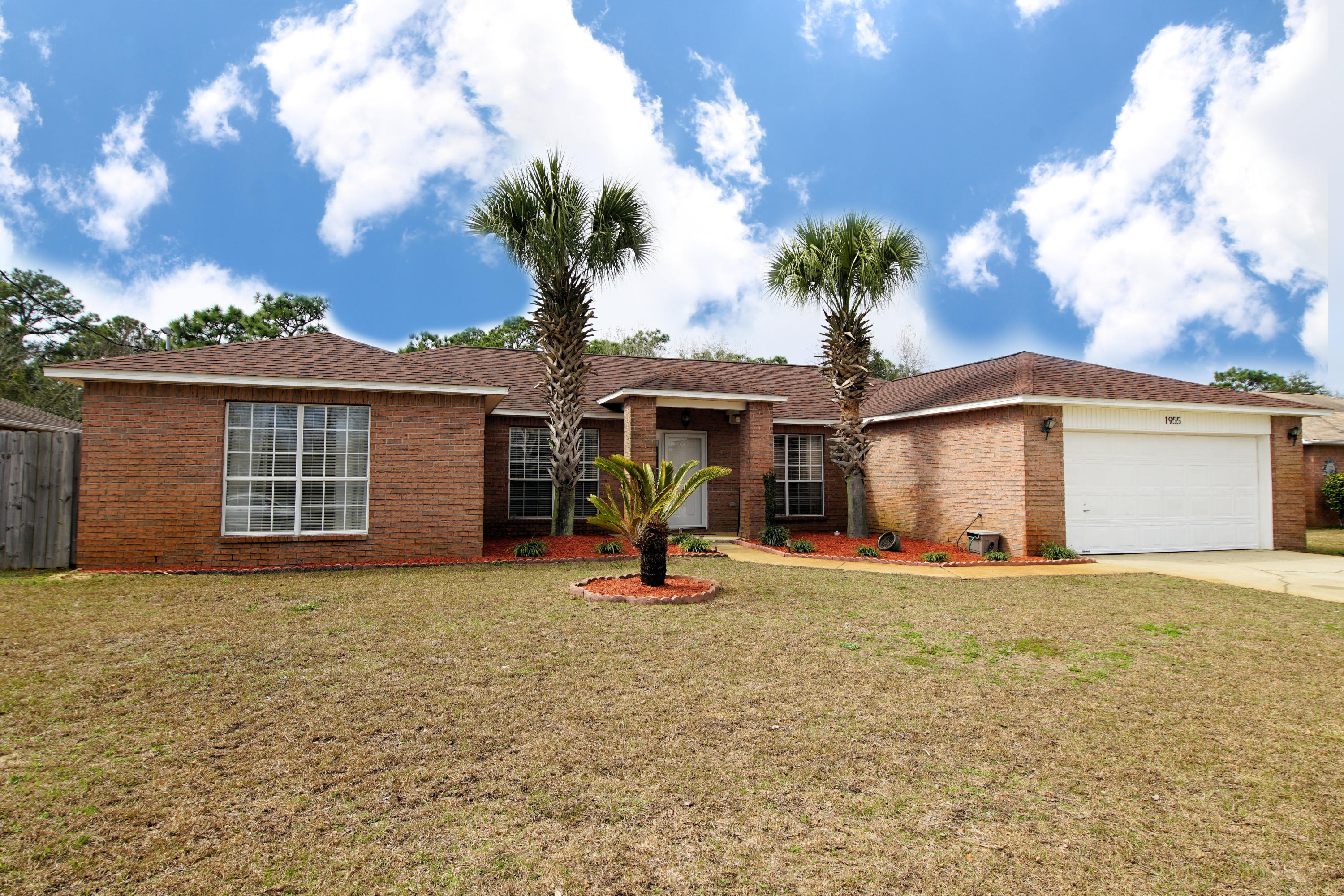 Completed renovated and move-in ready home with 4 bedrooms and 2 baths located in Navarre, FL! This home is located close to bases, beaches, shopping and restaurants! The roof was replaced in 2015, which makes the insurance low and affordable! As you pull up to the home you will notice the gorgeous tall palm trees that line the entry way! Enter through the storm door into a foyer with the dining room to one side and the home office to the other side of the entry way! This home features an open floor plan with the kitchen opening to both the living room and dining room. In addition there is a split floor plan with the master bedroom located on the opposite side of the home from the guest bedrooms! The kitchen and the bathrooms are completely updated! The kitchen features granite countertops, stainless and black appliances, a tiled backsplash, and new custom cabinetry to include glass cabinet doors and large brushed nickel hardware! In addition the kitchen has a tiled backsplash, a French Door refrigerator, built-in microwave, and Island! The kitchen sink has a picturesque window overlooking the large, fenced backyard! This kitchen is perfect for entertaining! The living room features vaulted ceilings and has French Doors to that open to an large Patio! All the flooring throughout the home has been updated to gray laminate and gray tile in the wet areas! In addition the lighting through the home has been updated! The master bedroom is large and has windows overlooking the back yard! The master bathroom features a modern vanity with granite counter tops and brushed nickel hardware and faucets. The home features a two car garage with an automatic garage door opener. The home owner has maintained this home impeccably and is offering a home warranty with basic coverage. Hotwater heater approximately 3 years old and HVAC approximately 7 years old. Buyer to verify all dimensions and information.