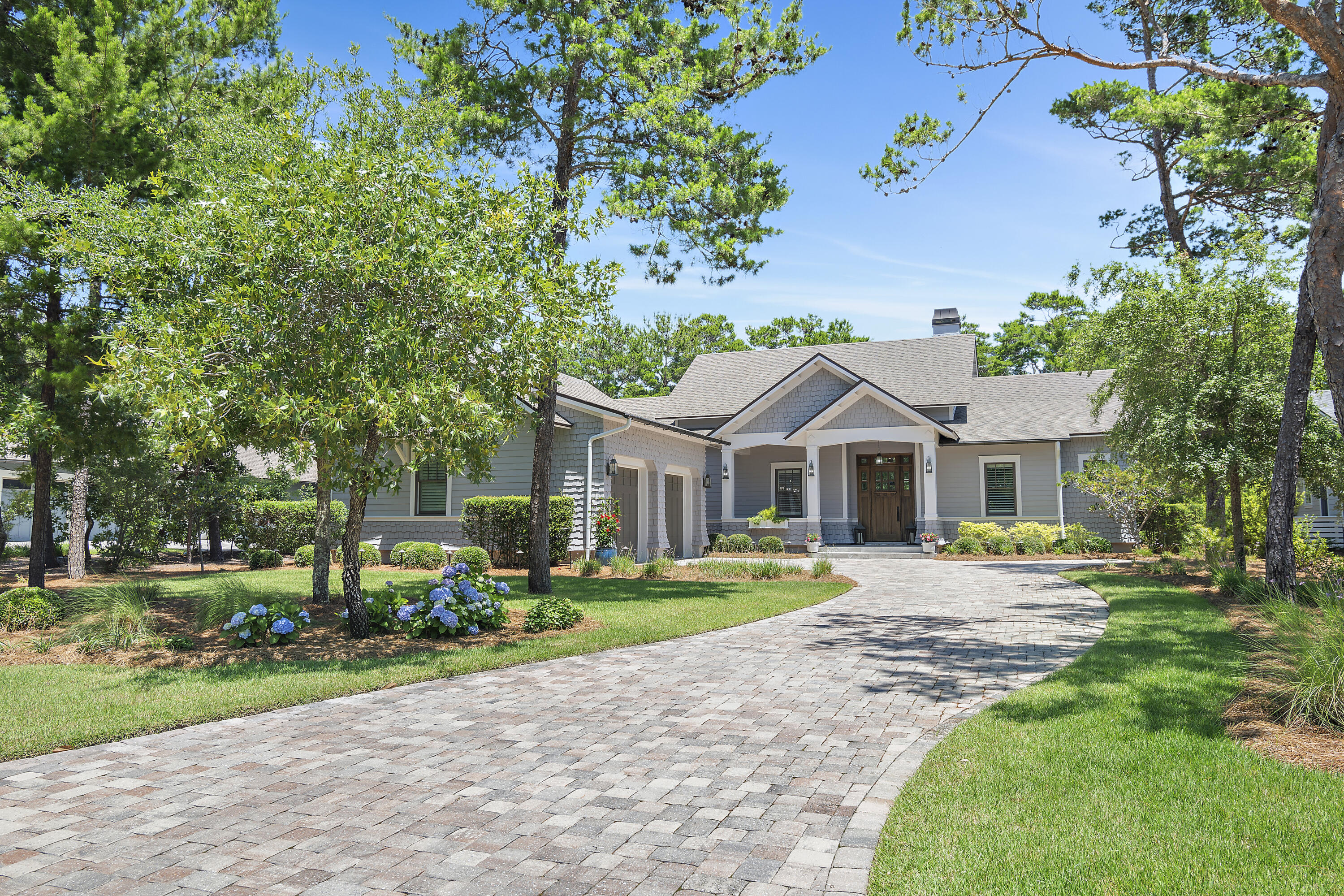 NOTE: The home has 3,528 total heated/cooled space with interior living space being 2,802sf and the garage 726sf h/c to total 3,528sf of heated and cooled space. One of the newest homes in Wild Heron, this pristine residence sits on an almost half-acre lot along the 10th fairway of the Watersound Sharks Tooth golf course. Presenting as new, this immaculate home is in a highly desirable location. Numerous upgrades and updates have enhanced the property, which boasts a screened-in outdoor living/entertainment space with surround sound, TV, gas fireplace and a fully equipped outdoor kitchen with a grilling station. Plantation shutters have also been added throughout the home along with custom E.F. San Juan cabinets and shelving in the living room and mudroom. Pillars flank the covered