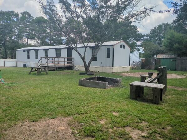 Charming, remodeled mobile home with modern upgrades and a spacious, open layout. Features a newer AC, updated master bathroom, and large master bedroom with cathedral ceiling. Includes separate kids' rooms, a generous living room with cathedral ceiling, and lots of cabinets in the well-appointed kitchen. The fenced yard boasts a large deck, a partial chicken coop, a fire pit, and an older RV perfect for a mancave, workshop or extra storage. Situated on a paved road in a quiet neighborhood near Hwy. 90, with easy access to Niceville, DeFuniak Springs, and Destin beaches. Bright, well-maintained, and ready for your family!