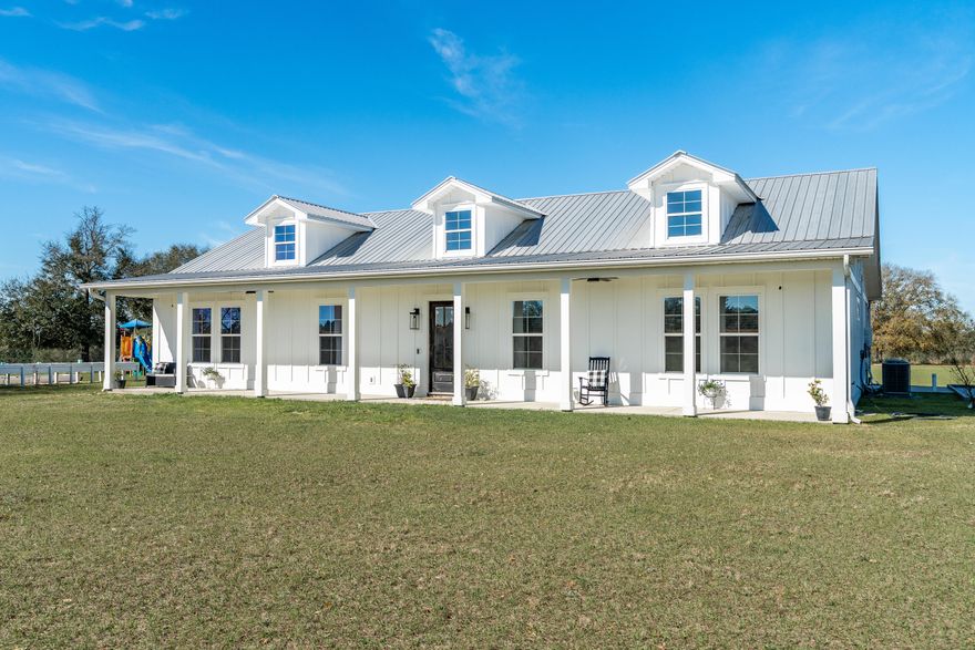 Welcome to your dream retreat--this stunning modern farmhouse, built in 2020, is perfectly situated on approximately 25 +/- rolling acres of natural beauty. With 4 spacious bedrooms ,3 full bath, and 1/2 bath in the main home, full bath in the barn, this home seamlessly blends timeless charm with modern design and comfort.Step inside to soaring ceilings, sun-drenched living spaces, and a layout designed for both relaxation and functionality. The luxurious master suite offers a peaceful escape, complete with a private office--perfect for working from home or unwinding in quiet solitude.Outside, the property is a haven for those who love the land. Rolling hills, fenced pastures, and a picturesque creek at the rear of the property set the stage for a truly tranquil lifestyle The impressive barn is thoughtfully equipped with horse stalls, RV power and sewer hookups, a full bath, and washer/dryer connectionsideal for equestrian use, hosting guests, or pursuing your favorite outdoor hobbies.

Whether you're soaking in the privacy, watching wildlife roam, or enjoying the breathtaking sunsets from your porch, this one-of-a-kind farmhouse offers the ultimate blend of elegance, comfort, and country living.