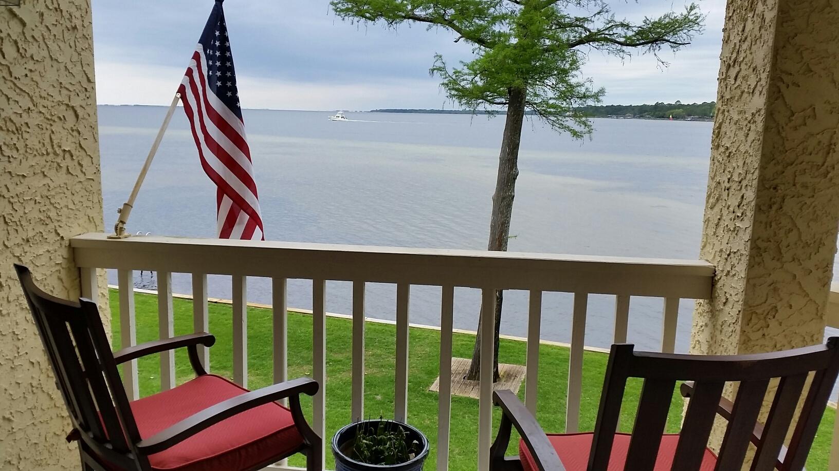 WATERFRONT, BEAUTIFUL SUNSETS! This gorgeous end unit on the second floor has been updated with all new kitchen, including soft close cabinets, light and bright granite countertops, and stainless appliances. This unit has been impeccably maintained with upgraded AC system, all new windows, custom window treatments, new bamboo wood flooring, smooth ceilings, new paint, and is very clean! The large wrap around deck can hold plenty of furniture, and you have total privacy. Looking out you see the intercoastal waterway, Rocky Bayou, with sailboats, dolphins and birds. Bicycle paths, and sidewalks lead to golf, tennis and marina in Bluewater Bay. This is unit is really nice... make an apt and come take a look! You wont be disappointed!