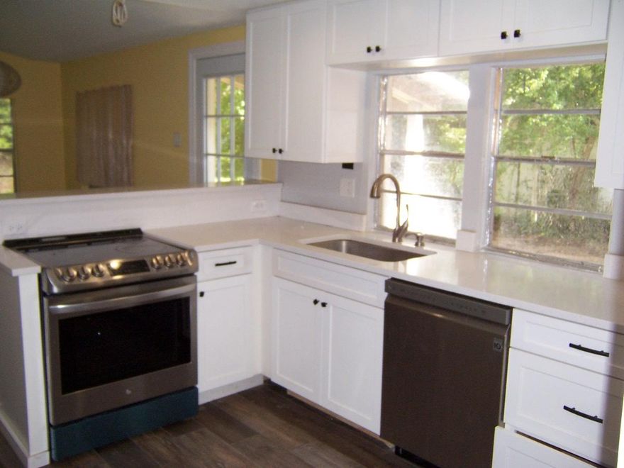 Brick house on almost 2 acres with private pond located just outside Crestview. Seller has updated the kitchen with new cabinets, can lights, sheetrock, paint, floors, granite countertops, sink, smooth top stove, stainless dishwasher, and more. New sheetrock, lights, paint, floorcovering, and updates throughout the home. Both bedroom have a waterview of the pond. Master bath has huge tile shower & 6x10 walk-in closet. The pond is stocked with huge fish you can see from the dock. Fenced yard area. Older workshop building and an attached carport give plenty of room for those outdoor projects. Also included is a huge 12x24 portable building facing the pond with tons of potential to be a fishing cabin, storage, waterfront exercise room, workshop, and more.