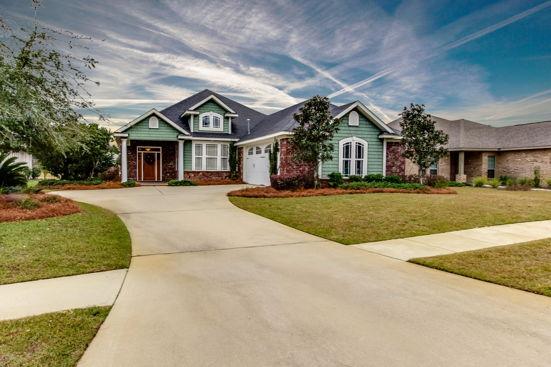 Absolutely GORGEOUS, one of a kind custom home by Marlin Design & Construction, winner of the 2007 Parade of Homes in Hammock Bay. This home is the original Marlin model home in Whispers neighborhood, with the builder sparing no expense when designing it with upscale attention to details. Situated on a large lot overlooking Whispers Lake, this home displays quality in every detail, inside and outside. Great floor plan, custom cabinets & built-ins, 2 pantries, large carriage entry double garage, full home security system, pre-wired for full house and exterior speaker system, granite countertops throughout, wainscoting, recessed lighting, coffered & tray ceilings, and fine finishings in every room. Exterior is beautiful brick with hardie board accents, with mature landscaping. Kitchen is a