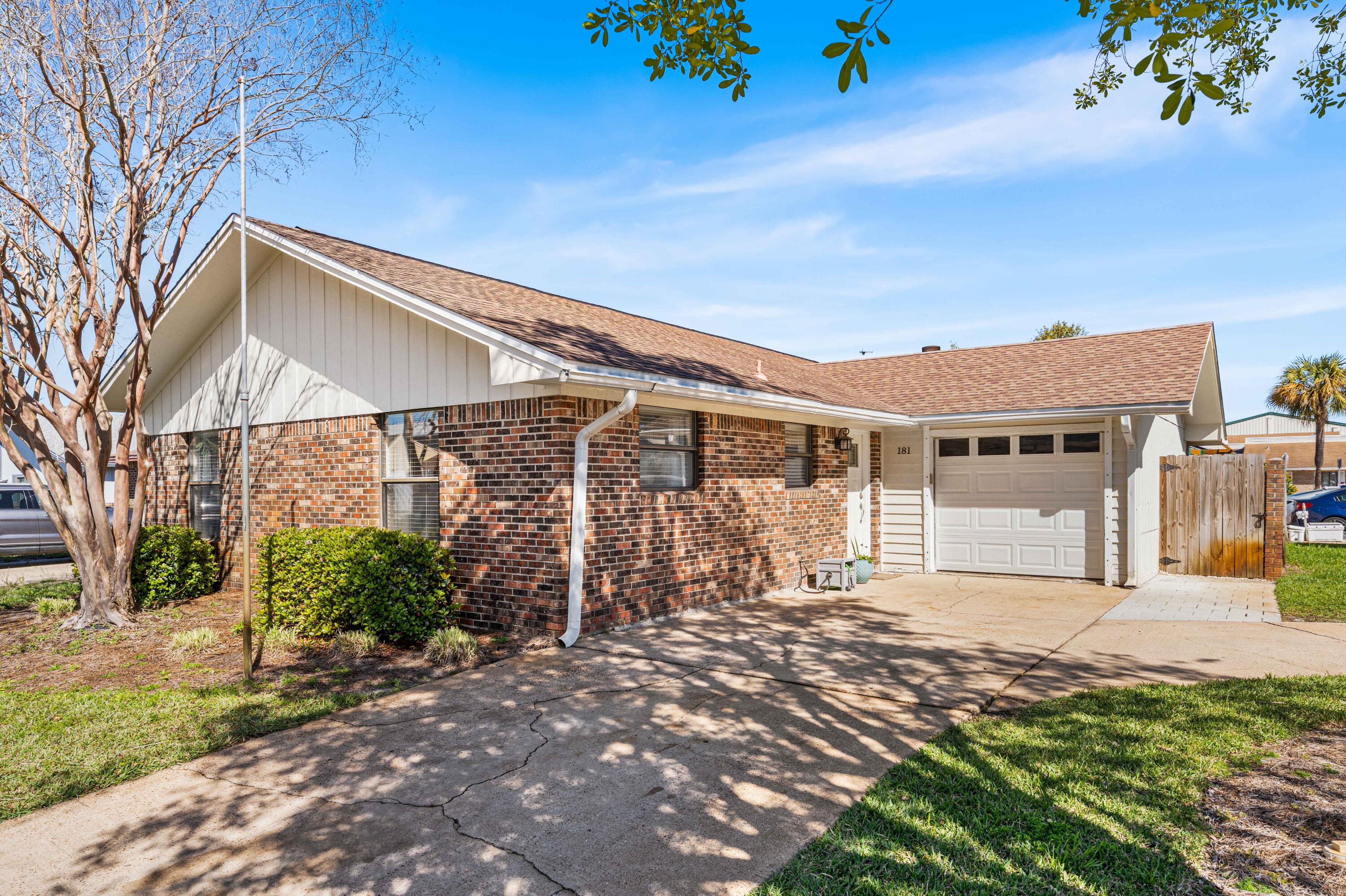 Seller offering $10,000 in closing costs with accepted offer. Move in ready adorable 3 bed/2 bath home in prime Destin location. Skip, hop, jump or scooter to nearby Destin Elementary, brand-new Publix, parks (one with a splash pad) and the Harbor. Modern updates include granite counter tops including breakfast bar, stainless appliances, new tub/shower enclosure in guest bath and custom built-in laundry closet including washer/dryer. Primary bedroom is large enough for king size bed and has easy access to back porch/yard. Two additional guest rooms are on opposite side of primary. The perfectly sized back yard features large slab with extended roof and ceiling fan, large grilling area with built in beverage fridge, bar area and additional deck. Additional storage and even room on the side yard for additional toys or yard equipment.
The single car garage is an added bonus, you can easily park 3 cars in the circular driveway. Hurricane proof fabric for windows included as well! Come make this your new home!