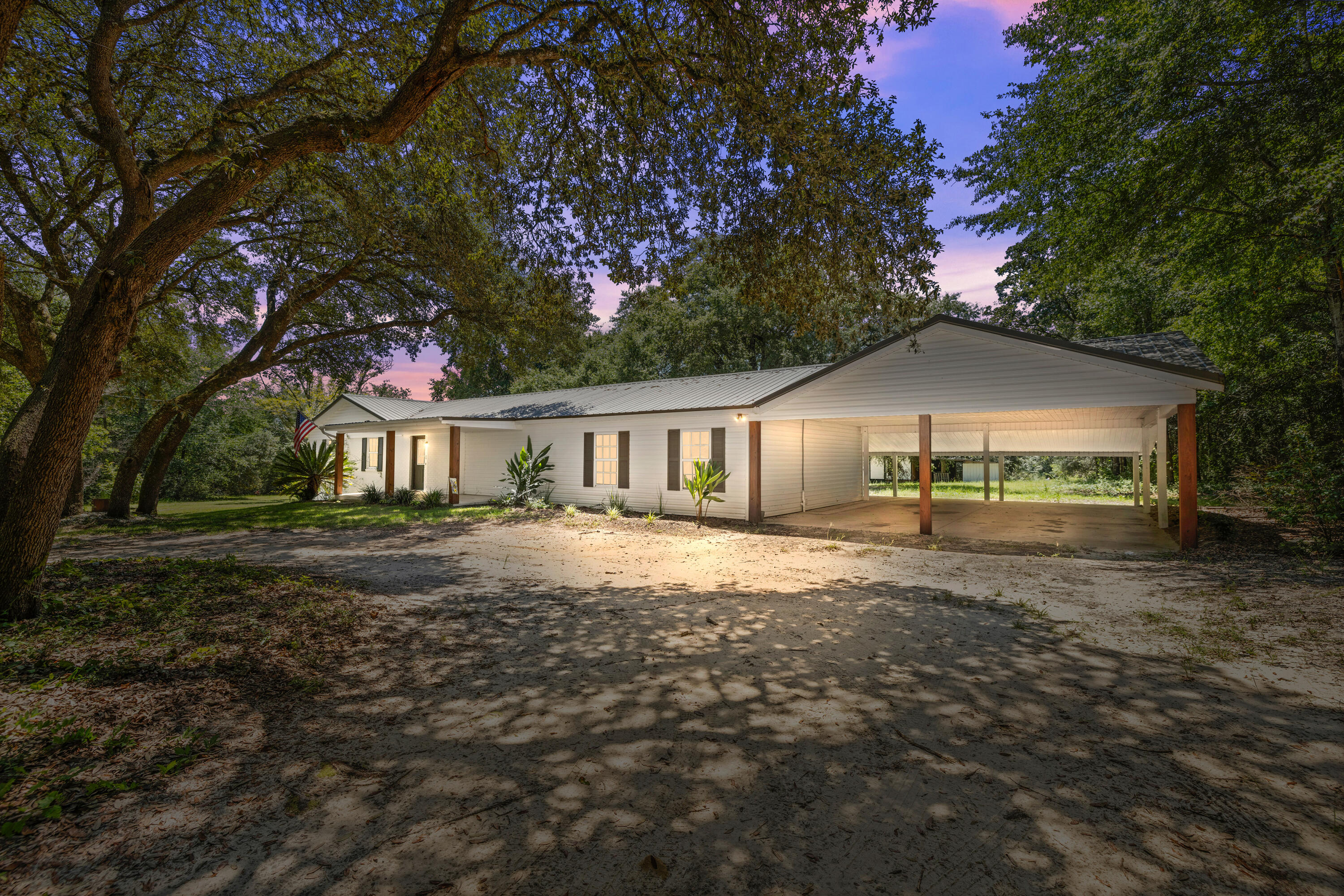 Professional photos coming soon. Charming farmhouse living on 4.05 acres! This 4BR/2BA home overs over 2,400 SF of space, including a sun-filled Florida room. Inside, the kitchen and baths have been tastefully updated while maintaining the warm country character that makes this home special.Recent improvements provide peace of mind: HVAC (2022), septic (2022), water heater (2020), and metal roof (2005).The acreage is full of possibilities-grapevines, walnut trees, and blueberry bushes already thrive here, while a mix of open land and shaded woods gives plenty of room to garden, raise animals, or simply relax. An outbuilding with covered space offers storage or hobby use and conveys as-is. Located in North Crestview with easy access to schools, shopping, and local bases, this home is also less than 45 minutes from Destin's white-sand beaches and under 30 minutes to Kings Lake and Rocky Bayou. A true blend of country charm and coastal convenience-don't miss out!