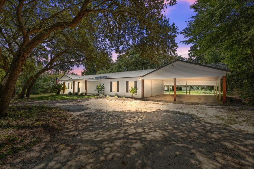 Charming farmhouse living on 4.05 acres! This 4BR/2BA home overs over 2,400 SF of space, including a sun-filled Florida room. Inside, the kitchen and baths have been tastefully updated while maintaining the warm country character that makes this home special.Recent improvements provide peace of mind: HVAC (2022), septic (2022), water heater (2020), and metal roof (2005).The acreage is full of possibilities-grapevines, walnut trees, and blueberry bushes already thrive here, while a mix of open land and shaded woods gives plenty of room to garden, raise animals, or simply relax. An outbuilding with covered space offers storage or hobby use and conveys as-is. Located in North Crestview with easy access to schools, shopping, and local bases, this home is also less than 45 minutes from Destin's white-sand beaches and under 30 minutes to Kings Lake and Rocky Bayou. A true blend of country charm and coastal convenience-don't miss out!