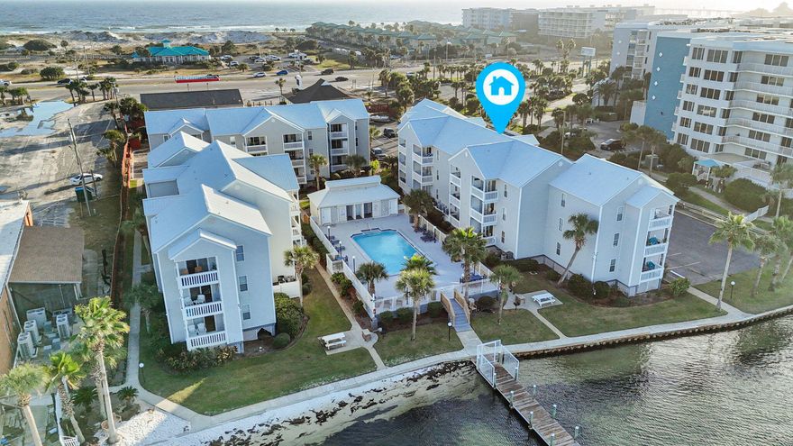 Experience the ultimate blend of relaxation and investment potential in this stunning, fully furnished 2-bedroom, 2-bathroom condo on Okaloosa Island. With 750 square feet of beautifully designed living space, this third-floor gem offers breathtaking, front-and-center views of Choctawhatchee Bay and sits just steps from the sugar-white sands and emerald waters of the Gulf of Mexico.Step inside to find luxurious wood grain tile planks flowing throughout, creating a warm, inviting atmosphere. The stylish decor continues with a custom made breakfast bar in the kitchen and thoughtfully chosen accents in the living room. From here, step out onto your private balcony and take in the sweeping, unobstructed views of the bay, with a bonus overlook of the sparkling pool below. This exclusive complex provides an array of amenities, including a waterfront pool, a private dock perfect for fishing and boating, a BBQ grill area, and a serene beach spot. With designated parking, visitor spaces, and easy access to the Okaloosa Boardwalk, Pier, and the famous Crab Island, you'll have everything you need right at your fingertips yet the complex remains tucked away from the main highway, giving you a peaceful, secluded feel.

Enjoy worry-free ownership with HOA dues covering water, trash, flood insurance, and quarterly pest control. Whether you're seeking a serene vacation escape, a primary residence, or a lucrative rental, this condo delivers on every front. Embrace the vibrant coastal lifestyle, with endless shopping, dining, and entertainment just moments away. Don't miss your chance to own a piece of paradise at The Hermitage on Okaloosa Island. VA Assumption 2.5%!