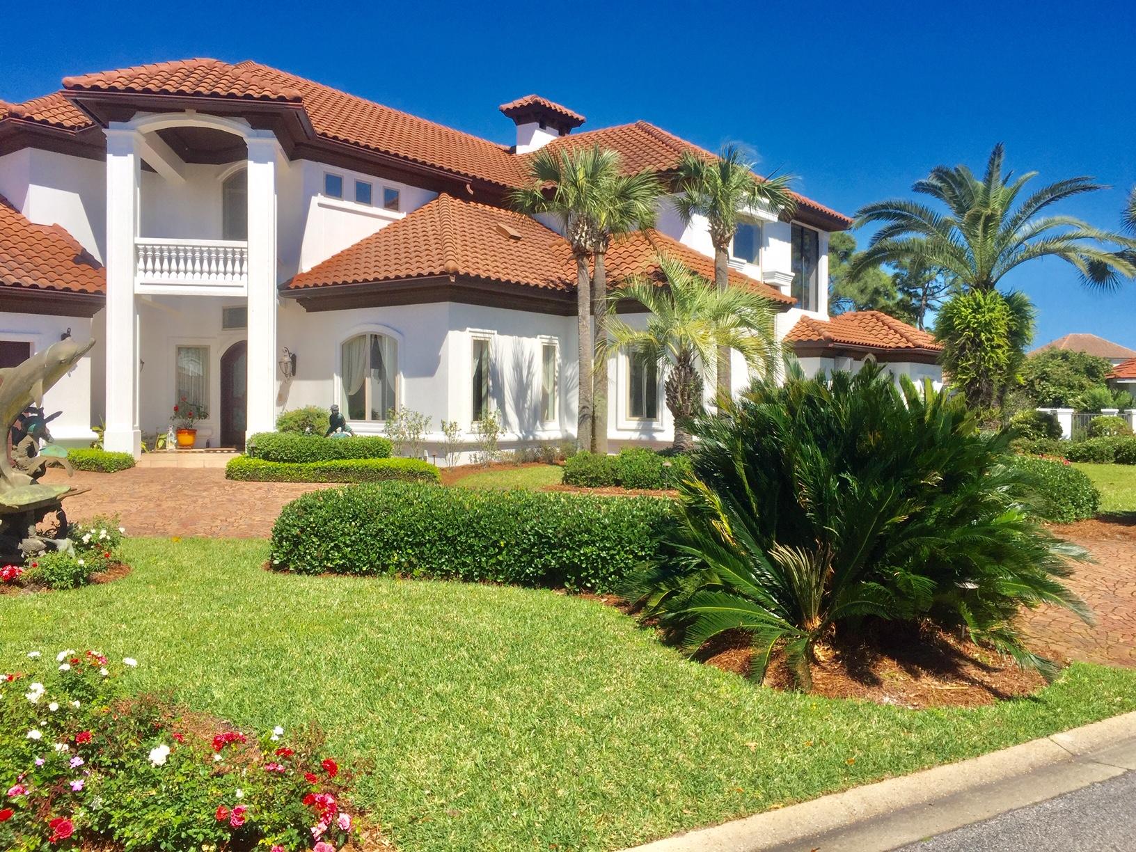 Greatly in demand Golf Course home on Regatta Bay Golf and Yacht Club overlooking 2 lakes and 2 bridges on hole #15. Majestic curved lot with oversized circular drive and separate drive for golf carts. Freshly painted and updated inside and out, trendy new lighting, and hardware.Awe inspiring entry reaches up to 23 1/2 ft. ceiling that carries through Great Room with two walls of almost all glass and 2 stack back DISAPPEARING glass doors. * GEO/THERMAL HEAT & AIR- 2 systems*GENERATOR, *STORM SHUTTERS No flood insurance required as elevation is over 16'Ft. House alarm and security cameras.  Large 4 piece crown mold system. 2 MASTER SUITES....one upstairs and one down stairs.  Grill and cabinets off of Master glass door are not attached and will not convey.