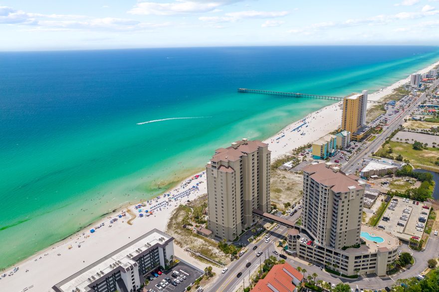 Welcome to Grand Panama Beach Resort! This well maintained 3 bedroom corner unit is perfectly positioned on the west end of the building, allowing for unparalleled sunset views. With an open concept kitchen, dining and living area, unit 1-1301 is not your typical condominium layout, providing plenty of room for entertaining. Once outside on the oversized balcony, the corner positioning really shows off the views that make this unit so special. With all hard surface flooring, new smart TV's and a recently replaced HVAC system, this property is truly a turn-key opportunity with rental projections exceeding $75,000 annually. Grand Panama Beach Resort is the newest luxury property on the beautiful beach of Panama City. Walk out the private gated patio directly to the pool, beach, or tiki bar