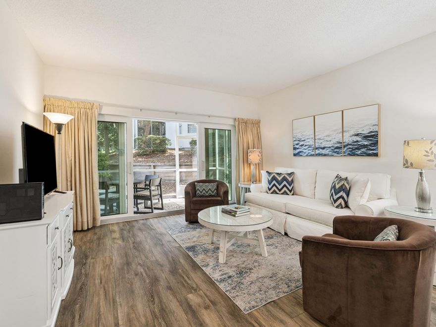 Set along the lush fairways of the Baytowne Golf Course within Sandestin Golf & Beach Resort, this turnkey, ground-floor condo in Tivoli offers effortless coastal living with serene golf course views and a rare, highly sought-after amenity: dedicated golf cart parking with a private charging station. This two-bedroom, two-bath residence with a bonus bunk room provides flexible sleeping accommodations, ideal as a primary residence, second home, or vacation rental. Natural light fills the open living area through new sliding glass doors, where beach-inspired furnishings complement the peaceful fairway backdrop. The updated kitchen features quartz countertops, a ripple subway tile backsplash, glass-front cabinetry, and a bright breakfast nook framed by floor-to-ceiling windows. Outdoor living is equally inviting, with a private courtyard perfect for morning coffee and a screened porch overlooking manicured greens and lush landscaping. The primary suite includes new furnishings and an updated bathroom with an oversized glass-enclosed shower, while the guest bedroom and custom bunk room comfortably accommodate family and guests. Additional upgrades include updated lighting, a new hot water heater, and a whole-house dehumidifier, ensuring year-round comfort and low-maintenance ownership. This move-in-ready villa also offers access to Tivoli's community pool and the full Sandestin lifestyle, including four championship golf courses, tennis, a marina, miles of walking and biking trails, and the shopping, dining, and entertainment of The Village of Baytowne Wharf. Whether you're seeking a low-maintenance condo in Sandestin, a rental-ready investment, or a relaxed Florida golf course retreat, this Tivoli residence stands out with its turnkey condition, golf cart convenience, and resort-wide accessibilitydelivering the best of Sandestin living with ease and style.