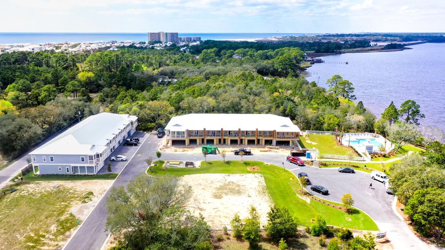 LAKEFRONT LIVING - New and move-in ready! See 'Virtual Tour' under 'Photos' for spectacular video. Miller's Landing is situated in a beautiful, waterfront community on Lake Powell just 3 miles from 30A and 8 miles from Pier Park. Enjoy the relaxed waterfront lifestyle of boating, kayaking or paddle boarding on the lake or going to the beach. The complex will have a total of 25 townhomes, a lakefront pool and a dock on Lake Powell. This spacious townhome offers a one car garage, 9 foot ceilings, stainless steel appliances, granite countertops, walk-in laundry room, all wood cabinetry, LVP and porcelain tile flooring, and impact rated doors and window