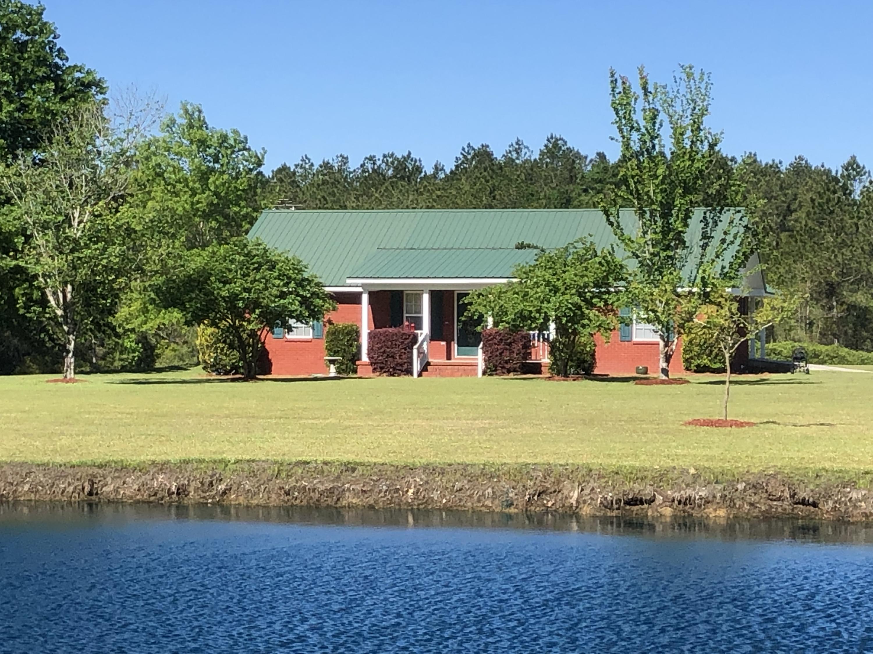 This property has it all with privacy, 37 acres, workshop, pond, and more. Brick home is in pristine condition tucked away by long private driveway and gated entrance. Split bedroom floor plan. open great room and kitchen with vaulted ceiling, covered front and back porch, tile and carpet flooring, central vacuum system, heat pump, double pane windows & doors. Kitchen is spacious with plenty of cabinets, work island with breakfast bar, Hunter ceiling fans. Master bath has garden tub and separate shower, double sink vanity, walk in closet. 24x24 attached carport, 24x30 workshop/garage, pond. About 5 acres is cleared and remainder wooded. Located near Ponce de Leon, this home is one hour drive to Panama City Beach, Destin, or Dothan.