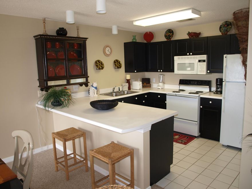 Gulf views and privacy from this 2nd floor unit. Amenities include heated pools, tennis courts, jacuzzi, amphitheater with summer concerts, restaurants and retail shops, and 3 deeded beach accesses. Bright and decorated for fun. This tasteful condo has coordinating colors, with furniture to match. On second floor for easy access, located in west end of building with better gulf view. King and queen beds. Bunk beds in hallway alcove, with privacy drape.