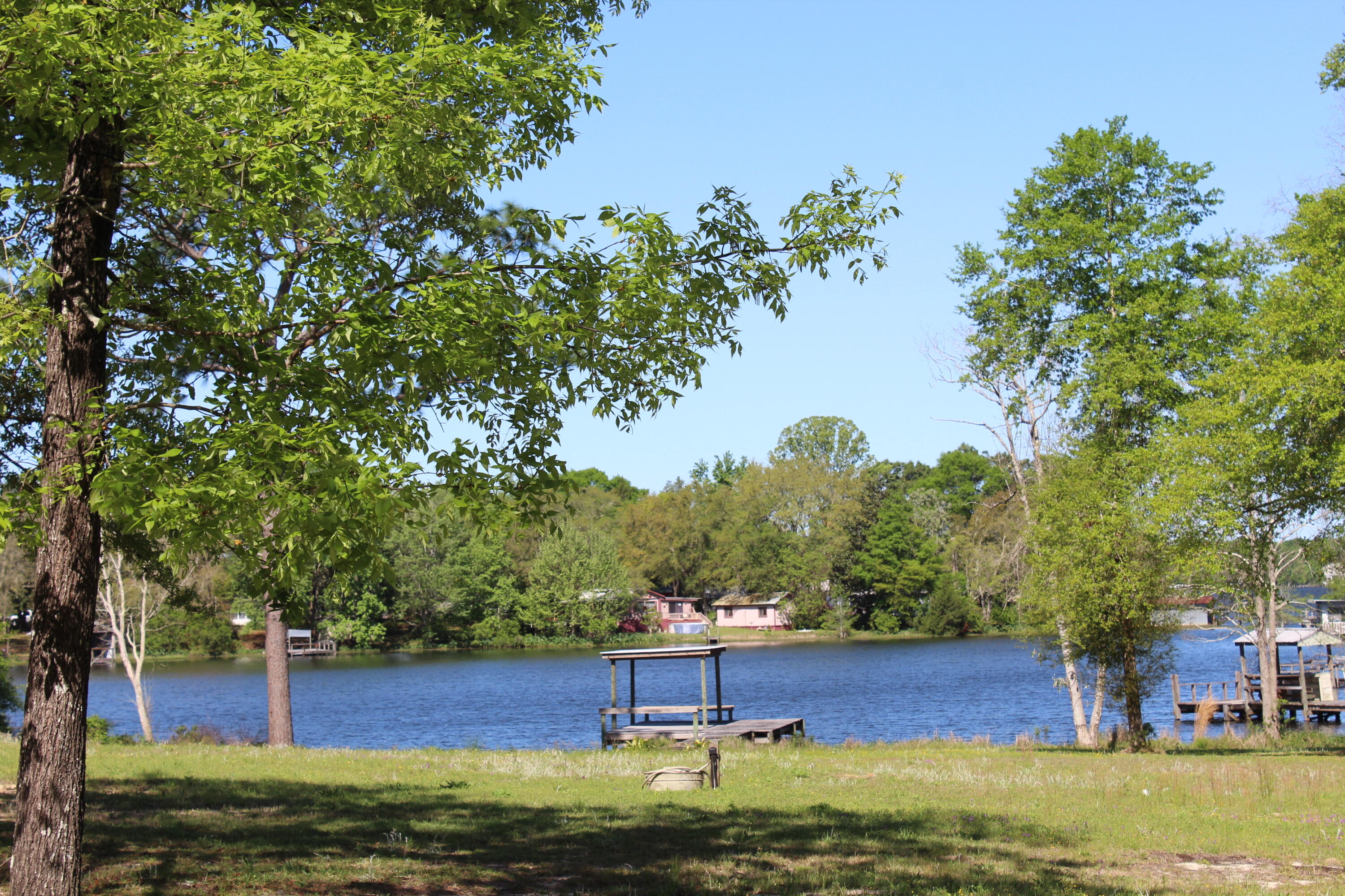 WATERFRONT ON LAKE JUNIPER INCLUDES A CUSTOM RV!! Beautiful 1.32 acre waterfront, parcel on Lake Juniper, a 620 acre state managed fishing lake, famous for record bass & bream. The property has aprox. 150 feet of waterfront on a spring fed sandy bottom cove that adjoins Lake Juniper. The property is one of the largest waterfront lots on Lake Juniper. Property has access from Widner Circle and Black Bass Blvd. For showing the property, seller has requested we enter from Black Bass Blvd. Fenced lot. Dock. You will love the 2013 Open Range Light Model 297 RSL RV in excellent condition. Full hook up includes private well, electric and septic. There is an additional RV hook up that includes water and septic only.