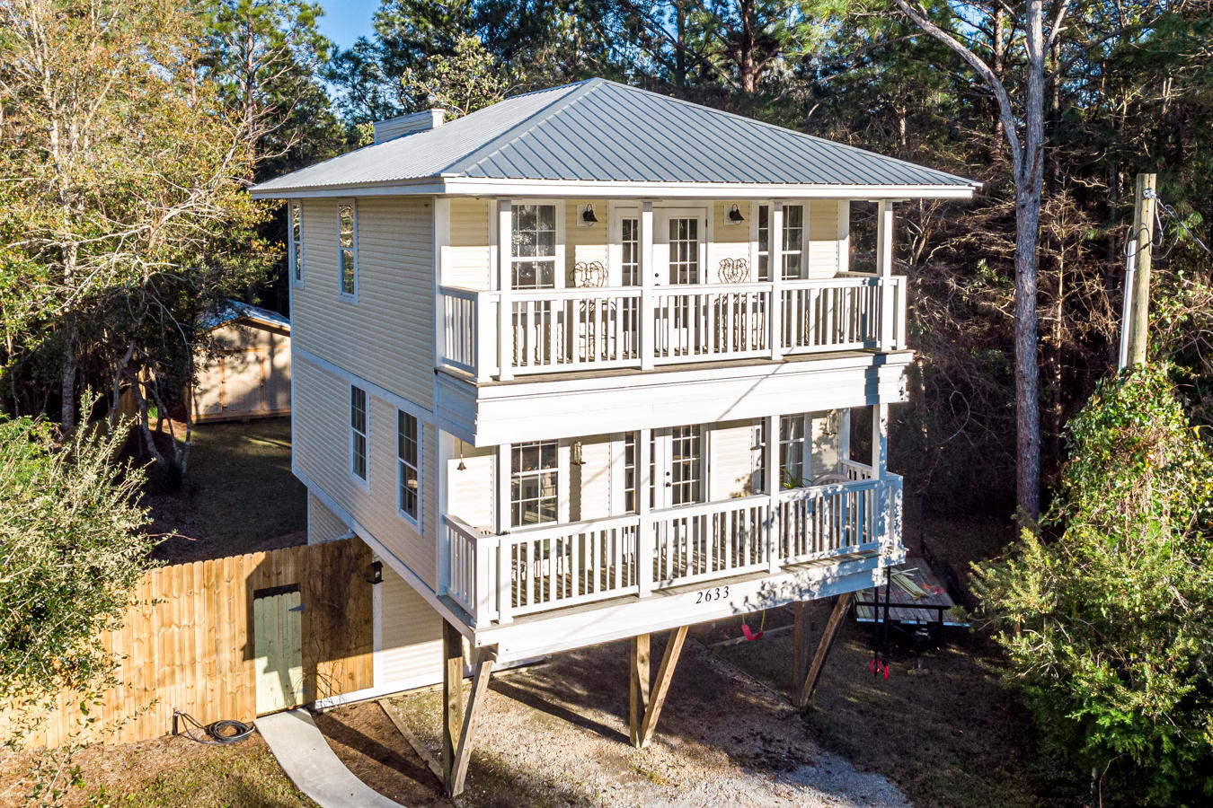 Lovely 3 story home with many updates and just 10 minutes from the beautiful beaches along 30A! Charming covered porches on the upper 2 levels. This home offers spectacular sunset views over the bay from the upper levels. Great privacy fenced backyard with 2 storage barns. Rich hardwood flooring throughout. Updated kitchen with stainless steel appliances, ceramic tile backsplash and a dining area. The lot is large enough to store a boat and the brand new boat launch is just down the street! Conveniently located nearthe beach, shopping and dining.