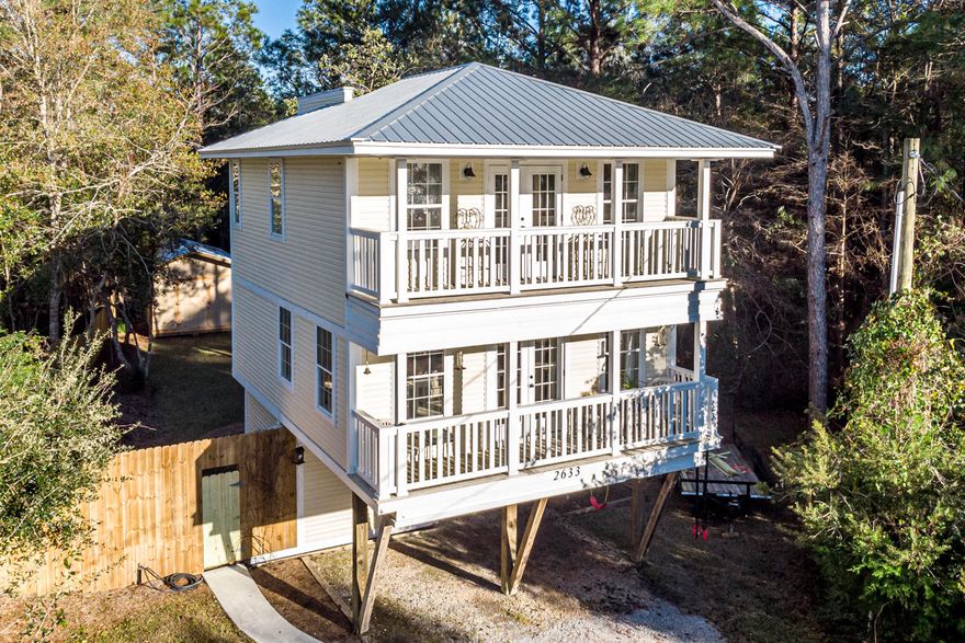 Lovely 3 story home with many updates and just 10 minutes from the beautiful beaches along 30A! Charming covered porches on the upper 2 levels.  This home offers spectacular sunset views over the bay from the upper levels. Great privacy fenced backyard with 2 storage barns. Rich hardwood flooring throughout.  Updated kitchen with stainless steel appliances, ceramic tile backsplash and a dining area.  The lot is large enough to store a boat and the brand new boat launch is just down the street! Conveniently located nearthe beach, shopping and dining.