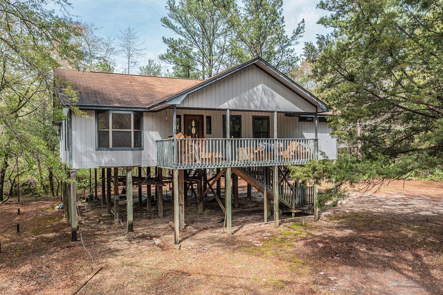 Private serene Stilt Home with 2 Bedrooms, 2 Baths on 9.15 acres with views of the Shoal river. This home has an open concept with a cathedral ceiling in the family room. The master bedroom has a master bathroom and the additional bedroom shares the guest bathroom across the way. There is also a utility room for your washer and dryer with a mud sink. Bring your kayak and relax on the river or have some fun fishing. Brand new plumbing throughout. 
16x16 utility building for all your outdoor supplies.