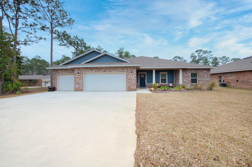 Beautiful newer one owner home located in a prime East Navarre location with many upgrades throughout. To begin, the exterior boasts the beauty and durability of brick with cement fiber board accents capped with an architectural shingled roof. The 3-car garage is modern and spacious with an extra-wide driveway. Additionally, an irrigation system and fenced backyard will keep the grounds lush. The back covered patio is perfect for grilling and entertaining guests! Furthermore, inside the home offers thick wood laminate flooring in the common areas, aesthetic neutral tile in the baths and laundry room, and carpeted bedrooms. Moreover, the Sherwin Williams paint color is accented with a wide baseboard, beautiful crown molding, and spectacular tray ceiling accents in the owner bedroom,