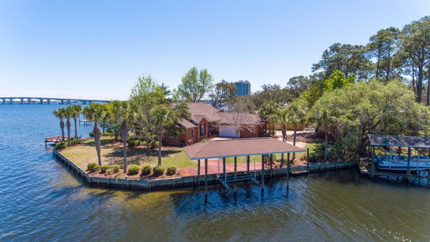 Truly one of a kind waterfront location! This gorgeous home is located on the landmark Paradise Point on St Andrews Bay in Panama City Beach, with deep water canal on one side and the bay on the other side. This private and tranquil location is an anglers dream!! Comes complete with a boat lift and 300 feet of waterfront. Other amazing features of this home include..bonus room, full length porch with ceiling fans, stainless steel Kitchen Aide grill, gourmet kitchen with commercial, Imperial stainless steal gas stove with double ovens, range hood & granite countertops, wine cooler & beverage fridge (let the entertaining begin) Another incredible feature is the 3 car, drive through garage. My favorite thing about this home are the magnificent views!! Water views, literally from every window.