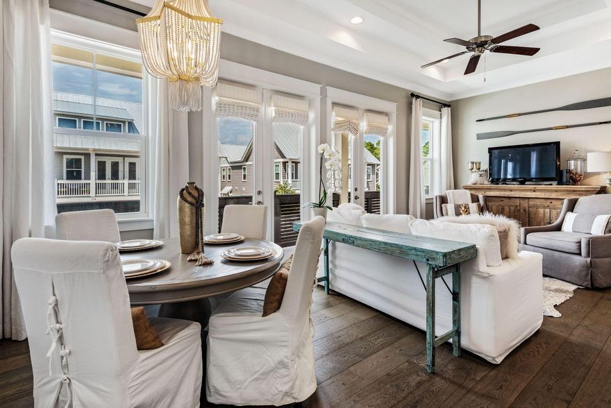 Located in the highly desirable neighborhood of Prominence, this two bedroom townhome sits just steps away from the neighborhood entrance, the resort-style community pool and the many shops and restaurants of The Hub. Natural light streams through the large windows and two sets of french doors into the open living area and kitchen. The kitchen features high end finishes, a gas range, granite countertops and a breakfast bar with lovely light fixtures flowing into the open living and dining areas. Soaring ceilings and beautiful hardwood floors run throughout this townhome. The master suite and guest room are nicely separated on opposite sides of this Aruba floor plan. The master suite features a walk-in shower and double vanity. Near the guest room, there is an additional full bathroom with