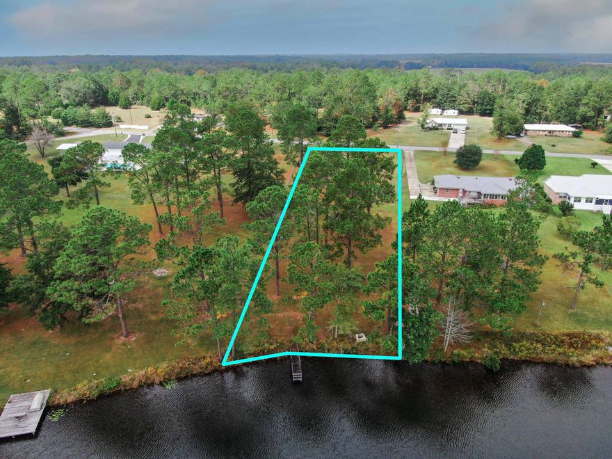 Fantastic waterfront lot in Ten Lake Estates,  planted in grass; mostly cleared with mature pines, confederate roses and crepe myrtle. Wonderful building lot with very gentle slope and older dock. With a voluntary HOA, this nearly 1 acre lot is in a prime location, just 5 miles to downtown historic DeFuniak Springs. No utilities in place but electric & city water is available with septic being required.