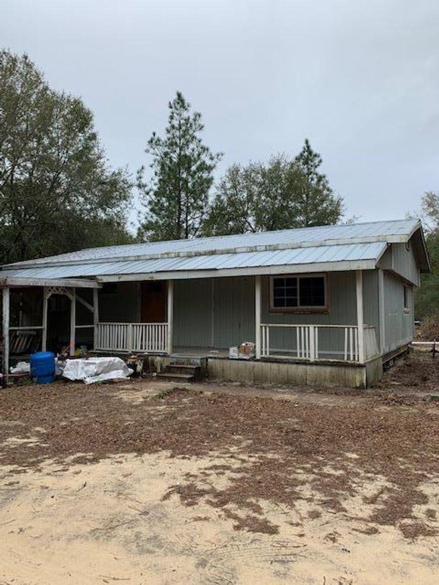 Great investment opportunity!  3.14 acres with city water and two septics.  Could be an income producer with more trailers added.  No restrictions known.  Older doublewide mobile home on property that seller started to remodel, but it has not been completed. It could be used as workshop or storage shed in its present condition.   It will not go financing. New RV hookup on property, but the RV present does not stay. Land is flat with trails cut throughout the land.  Driveway is nearly complete to access subject directly from paved road.  Survey done in Feb, 2021.  Offers to be submitted on AS IS contract.  Buyer to verify all pertinent information and perform all due diligence.