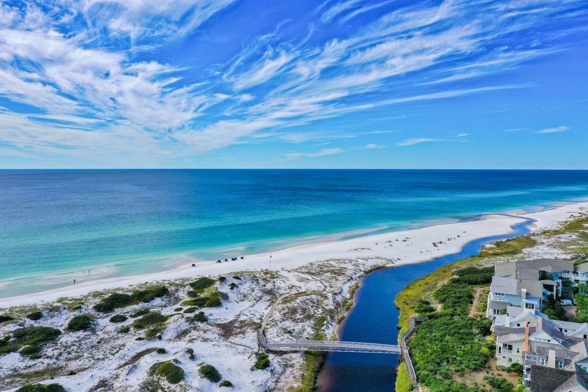 Fully renovated first row Gulf-facing home in Watersound offers stunning views of the Gulf. Completion January 2021. Towering sand dunes and Camp Creek offer privacy that truly transcends everyday life. Listen to the Gulf waves from the glamorous outdoor bathtub, or relax with family on one of the deep-sized private balconies. Direct beach access is just opposite the outdoor shower. Carefully selected finishes that adorn the bath areas include Akdo Tile in Calcutta Gold and limestone, white carrera mosaic marble and Thassos marble. Cabinetry is crafted by Markus Dannecker, a 5th generation Swiss Cabinet Maker. The kitchen island is of bleached walnut. Bath works by Hansgrohe and Lacava.