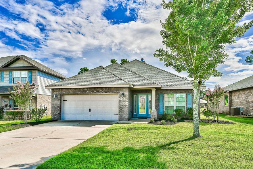 Water views and modern finishes combine to create the ideal indoor-outdoor living space in this nearly-2,000-sq.-ft., all-brick home in the coveted coastal community of Driftwood Estates. Positioned on a lakefront lot, this three-bedroom home with a dedicated office features an open floor plan, lush landscaping and low-maintenance wood and tile flooring throughout. High ceilings add a welcomed airiness to this home, which has a rare wood-burning fireplace in the living room and a thoughtfully-appointed chef's kitchen with granite counters and stainless appliances perfect for primary living at the beach or a long-time rental property for investors. The spacious owner's suite boasts custom cabinetry in the walk-in closet and an en suite bath with both garden tub and walk-in shower. A welcoming covered front porch greets visitors and a spacious rear porch overlooking the water and fenced yard is an ideal place for relaxing at the end of the day. Driftwood Estates has a community pool, playground and 11-acre park with sports courts ranging from tennis to pickleball to basketball. Washer & Dryer will convey as-is.