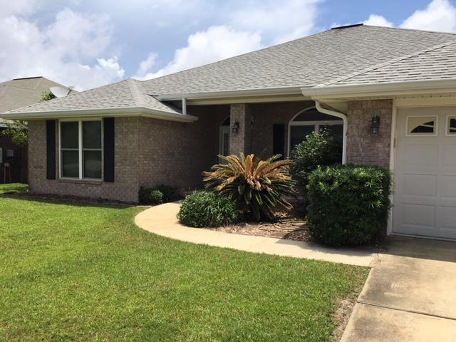 Ready for you! Great neighborhood with underground utilities and traffic light off Hwy 98. Only 4.5 miles to Navarre Beach and 9 miles to Hurlburt Field. This all brick ranch features 4 bedrooms, NEW flooring, and a fenced backyard. PLUS there's an eat in kitchen, formal dining room and large open living room. You'll appreciate the high ceilings, neutral colors, wood burning fireplace and architectural details. The split bedroom floor plan boasts a master bedroom with double vanities and garden tub. FREE One year home warranty too!
