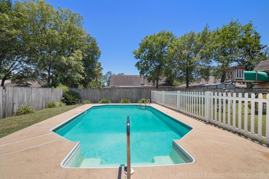 Perfection from the moment you enter with the keyless entry to the time you step out to the in ground pool. Interior features 5 bedrooms and 3 full baths. As you enter you will fall in love with the hand scraped wood floors that have just been installed. But don't stop there, check out the spanish lace ceilings and walls, vaulted ceilings, and stunning kitchen. The kitchen boasts Kenmore Stainless Steel appliances (5 burner gas stove, built in microwave, dishwasher, side by side fridge, and disposal), Granite counters, hand scraped wood flooring and rubbed black pulls throughout. There is a formal dining room and separate eat in area offers plenty of space for your needs. Downstairs you will find the master bedroom with wood floors and two additional bedrooms. The upstairs has an open loft space, 2 bedrooms, and a full bath. Step outside to the screen porch to view the backyard and stunning in ground pool and spacious yard with a child's play set. This home has been well maintained with new HVAC unit in 2013, new wood flooring, tile floors in all wet areas, new granite counters, and in ground sprinkler system.  Located in South Crestview and close to EVERYTHING!