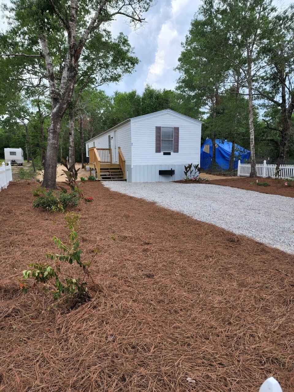 Come check out this move in ready mobile home. It is ready for someone to call it home! Located on a private street in the Oakwood Lakes Estates neighborhood. This lovely home is a well maintained 3 bedroom 2 bath and has two porches, a partial picket fence, new metal roof, LVP flooring, fresh paint, and new appliances. This mobile home has a skirt surrounding it and a wire mesh net to protect the underbelly of the trailer. Come fall in love with this affordable home and bring the finishing touches to make it your own.
