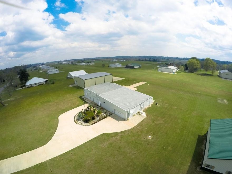 Airplane Hangar Home in Sky Park Community in Baker FL, A must see for any Airplane Buff, loaded with lots of amenities and extras, one of a kind in the area, keep your airplane in your garage.1452 Vinson Ray Rd, Baker FL, AirNav18FD 3500 ft grass strip, maintenance and fuel on the field 1.3 Acres remote electric driveway gate NW junction box at end of driveway has phone/DSL, RG5,and fiber optic under ground to the hangar building NE junction box at end of driveway, 110 electric for sign, outlet, and gate 6inch thick driveway concrete 4500 PSI strength 95 cubic yards concrete aircraft parking ramp with concrete taxiway to the runway