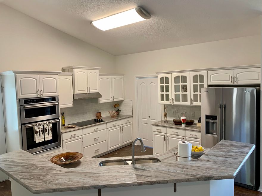 This has been put into pristine condition-New Roof, newly remodeled kitchen and baths with granite,new stainless steel appliance package, new fans and lights,new textured ceilings, new laminate flooring and carpets- Cute as a button and nice lot--deeded waterfront access, a boat launch, fishing pier/dock, club house, with fitness center, a pool and tennis courts.