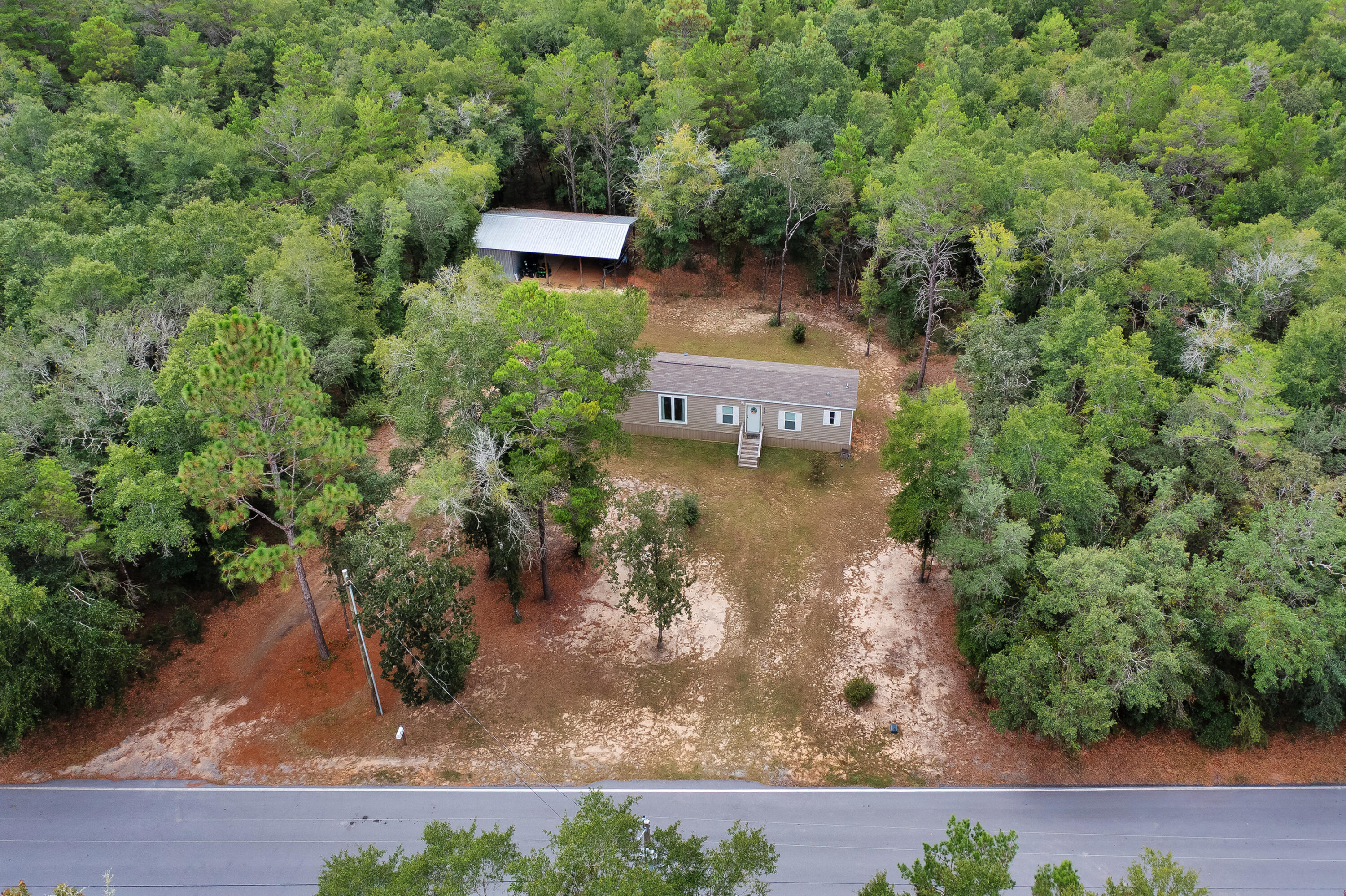 Discover 5 acres in Crestview featuring a 2021 manufactured home with open living and modern finishes. This property features a 40x20 workshop/barn equipped with water and electricity, providing ample space for projects, storage, or equipment. The acreage offers privacy, flexibility, and room for future use, while still being conveniently close to town amenities and main routes--a rare opportunity to own land with utilities in place and a move-in-ready home in a sought-after location. Schedule your showing today!