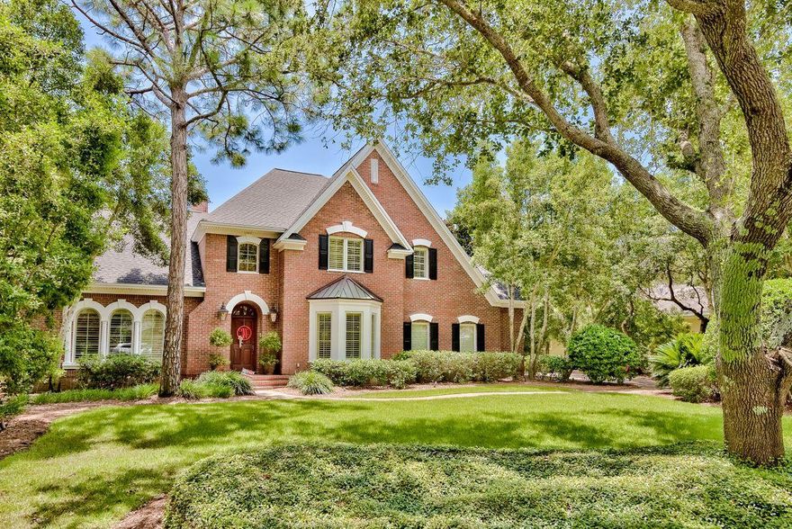This serene and spacious home sits on a leafy lot graced with established trees and shrubs in Kelly Plantation. Step through the custom mahogany front door and take in the polished wood flooring, a craftsman staircase, and an attractive open floor plan. The double-story family room offers an abundance of natural light, an elegant chandelier, built-in bookshelves, and a gas fireplace. A formal dining room with a wet bar provides the perfect place for family meals, and the gourmet kitchen includes a breakfast bar and nook. A noteworthy first floor owner's suite features a deep coffered ceiling, a walk-in closet with custom shelving, and a completely remodeled bathroom with Catalina marble counters and bath surround including a large tiled glass shower. Upstairs, a galleried landing leads to a bonus room and three generous guest bedrooms. 

Behind the home is an outdoor oasis with an enclosed pool, spillover spa, and private outdoor living area. Located inside the gates of Kelly Plantation, residents can enjoy access to several neighborhood amenities, including a gym, owners club, community pool, golf course, playground, and nature trails.