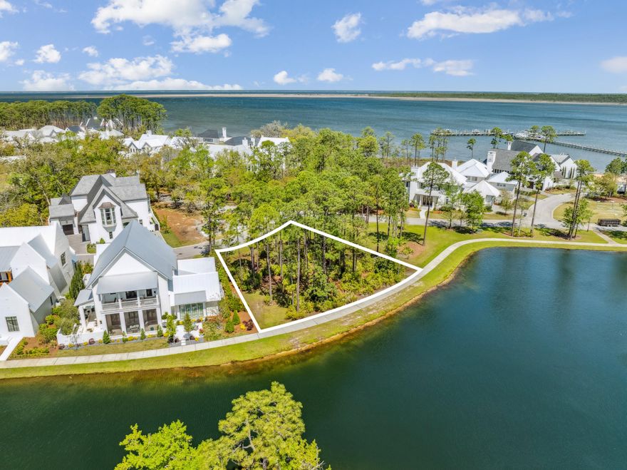 Rare opportunity to acquire a prime vacant homesite in the coveted waterfront community of Churchill Oaks! Located on a desirable corner lot, this expansive lakefront property offers breathtaking views in every direction--including a glimpse of the bay through the surrounding nature preserve--and comes with the option to purchase a 50-foot private boat slip in the community's deep-water marina. Notably, there is no lot to the north, providing enhanced privacy and a clear, unobstructed landscape. Design and build your custom dream home in one of South Walton's most sought-after bayfront communities. A preliminary design study by Matt Savoie is included with the property. Renderings can be found under the Documents tab. Nestled amidst native vegetation and the serene waters of Hogtown Bayou, Churchill Oaks embodies a lifestyle of luxury and natural beauty. Once you pass through the stately gated entrance, you'll be greeted by magnificent coastal homes that highlight southern architecture, all shaded beneath majestic oak trees. This 40-acre community features 87 homesites and some of the finest amenities in South Walton. The latest addition to the community is a deep-water private marina, which includes 36 private boat slips (available for purchase separately), paddleboard storage decks, a fish cleaning station, shoreline stabilization, and more. The Churchill Oaks Clubhouse is an exceptional 8,000-square-foot amenity perched on a point overlooking the bay, offering stunning views. The clubhouse features three pools, an exercise room, outdoor bar, fully equipped media room, commercial-grade kitchen, bath and locker rooms, and ample gathering spaces for residents and their guests to enjoy.