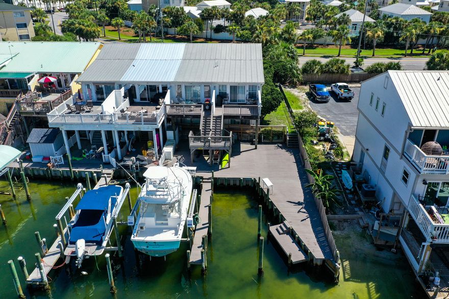 Beautifully well maintained waterfront end unit townhome with the only greenspace side yard for play and pets. This boater and watersports dream comes complete with a 42' boat slip, kayak/ paddleboard launch and outdoor shower. Enjoy the best of both worlds with deeded beach access and direct Gulf access through the Destin Harbor. New flooring upstairs, downstairs bedrooms and new carpet on the stairs. Owners closet. Sold furnished.