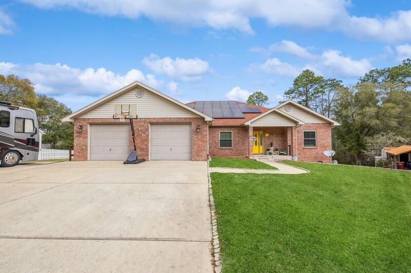 Stunning 4bd/4ba golf course home, south of I-10, with saltwater pool and hot tub! 2,633 sq ft split floor plan with flex room perfect for guests/play/office/gym. Home features: Paid-off solar panels, heated/cooled basement with golf cart garage -perfect mancave, outdoor bathroom with shower for pool days, oversized 2-car garage, and 2 massive driveways for cars, boats, or RVs. Large kitchen with ample storage, stainless steel appliances, and master bedroom with tray ceilings and ensuite bath with garage access. Comfort, convenience, and a perfect space for entertaining - this home has it all!