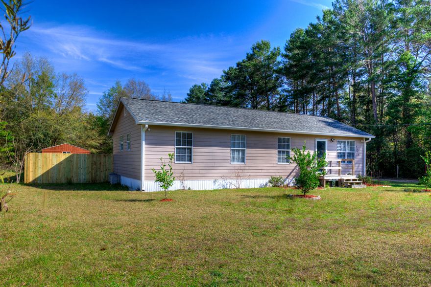 Super cute Florida cottage that has been completely updated. This home gives your the best of both world country living and a hop, skip, and jump away from the beautiful Navarre beaches. HVAC has new coils and a ultra violet system, ducks have been cleaned, water purifying system, newly painted, LVP flooring, spray foam insulation under the home and new blown in the attic, water heater and roof 2021. The Hardy Plank siding adds to the charm of this home and it is surrounded by beautiful fruit trees, and flowers.  The large lot in the back of the home boasts a one of a kind smoke house and a large detached workshop/yard building and plenty of space to play golf frisbee.