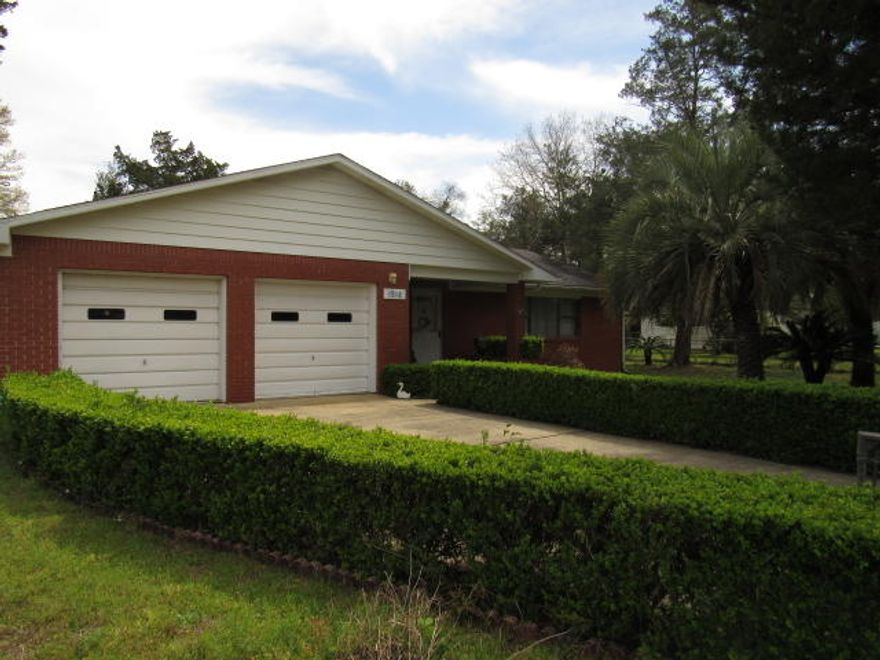 **BRAND NEW ROOF**JUST REDUCED**Step into this SOLID BRICK, well maintained, ONE OWNER home. Plenty of opportunity in this home!-over 2,000 sqft! 2 MASSIVE central living areas furnished with a stone decor wood burning fireplace. Large Kitchen with walk-in pantry's. Additional room off kitchen could be used as 3rd bedroom, just add closet or wardrobe. Master Bedroom with built in vanity, Full Bath and his/her's walk-in closets. You'll find the second bedroom down the hallway as well as a full bath and additional 1/2 bath. Giant 2 car garage and Sun Room. Washer/Dryer Convey. Property has been termite treated yearly. HVAC 2010, and serviced yearly. Lush manicured lawn with Florida palms throughout. Backyard has a large raised garden bed with fruitful blueberry bushes.