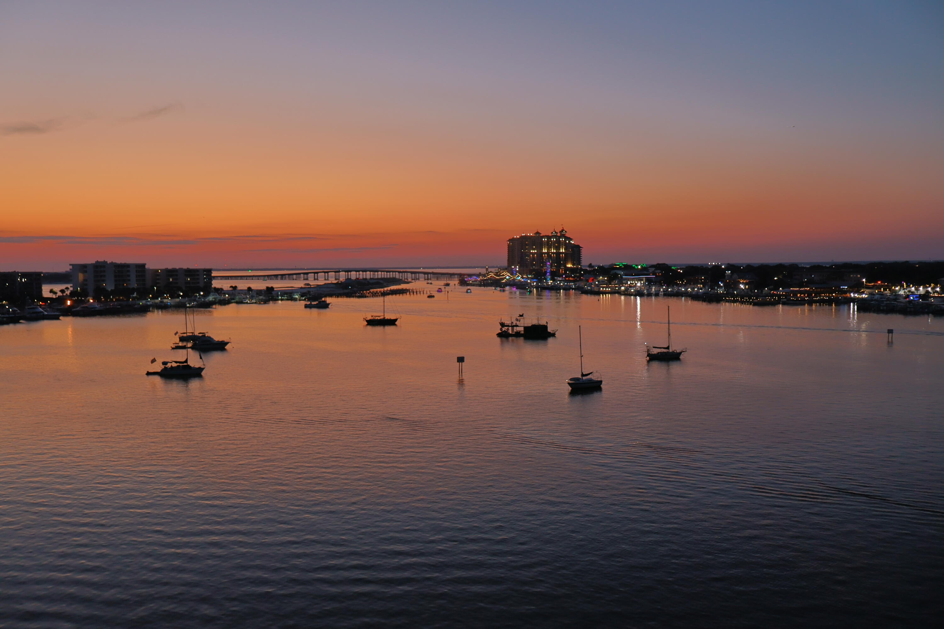 Your breathtaking waterfront story begins here, from sunrise to sunset. Perched on the top (7th) floor of Destin Harbor Resort West, this 2-bedroom, 2-bath penthouse condo offers a front-row seat to the best of Destin's vibrant harbor life. Picture yourself on a summer evening, a drink from your wet bar in hand, watching the fireworks sparkle over the water from one of your two private balconies. Or imagine lazy afternoons, with gentle harbor breezes and the soothing sound of passing boats. This is not just a home; it's a lifestyle. For the water lover, this property is a revelation. Included with the unit is a private 16,000-pound boat lift and two premium garage parking spots--a rarity in this area. The tastefully appointed and furnished interior boasts a modern kitchen with sleek, white cabinetry and newer stainless appliances. Large sliding doors in both the living room and bedrooms open up to the water views, ensuring you never miss a moment of the magic. The updated building, with its fresh lobby and common areas, is a testament to the quality of this exclusive, gated community, which also features a waterfront pool and terrace. This is a rare chance to own a piece of paradise. With 12+ month rental restrictions, this is a quiet, exclusive lock-and-leave retreat for your escape to the water. A 31' Regulator currently on the boat lift, is also for sale, but move quickly as it's attracting a lot of interest. Holiday Isle offers two gated beach access points and there are also public beach accesses in the area. The most famous is Norriego Point, where boats park on the sand to hang out. Just a couple of miles from the Destin Executive Airport, this location also caters to pilots looking for a quick visit to the beach. The HOA is very accommodating of boat owners and will assist in securing a more significant slip if required, subject to availability. The condo association has completed all required inspections and reserve requirements and the HOA is extremely well managed.